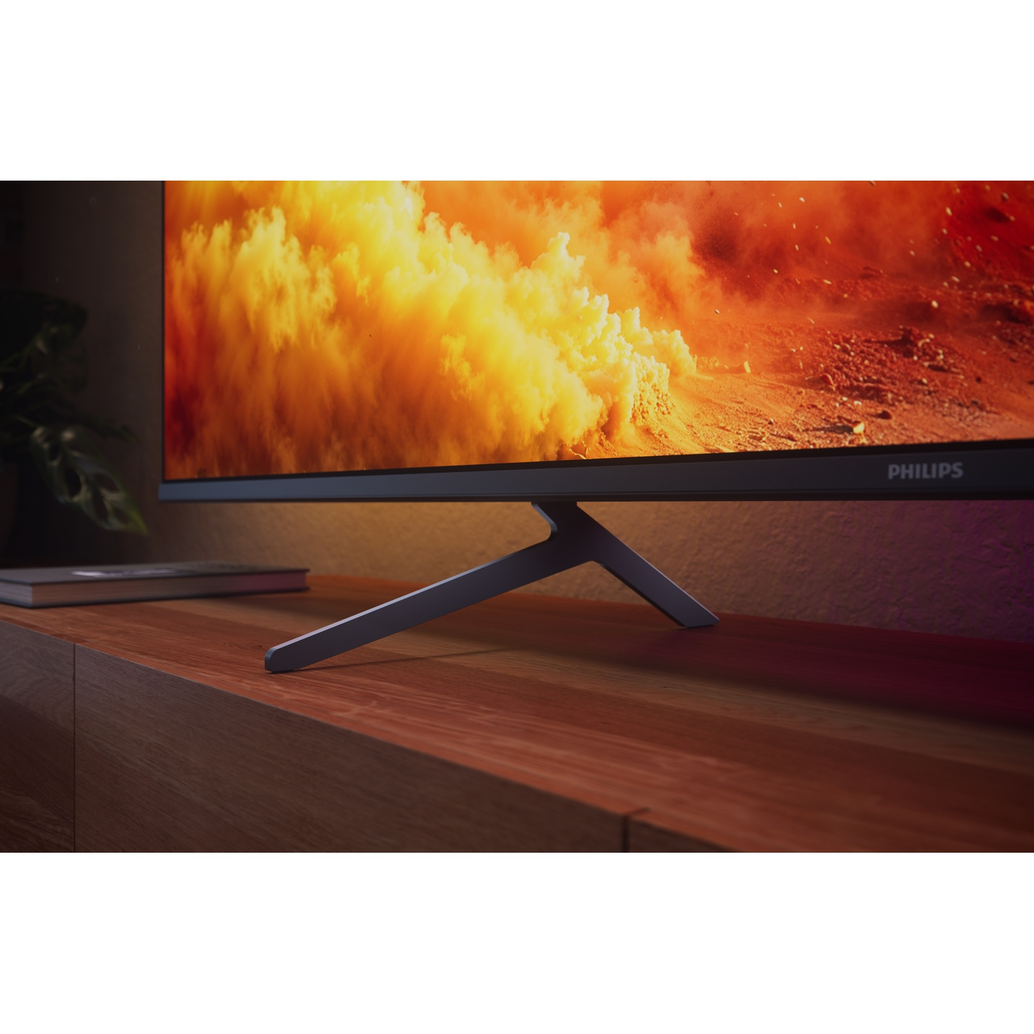 A monitor displays a fiery orange and yellow explosion over a rocky landscape.