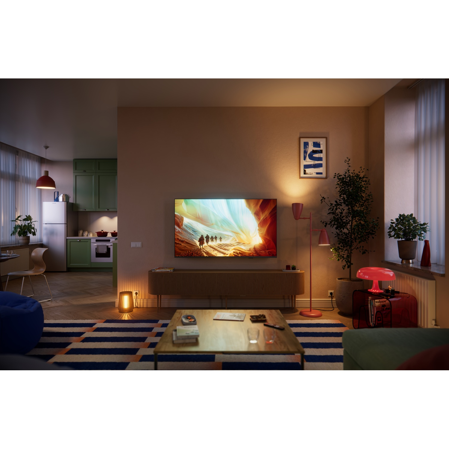 A living room with an open kitchen, a TV, and furniture.