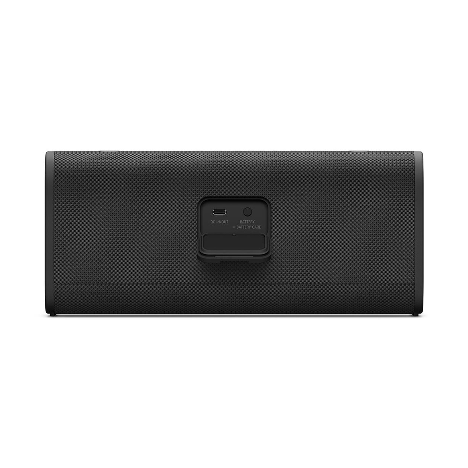 Altoparlante nero con coperchio porta etichettato DC IN/OUT e BATTERY - BATTERY CARE.