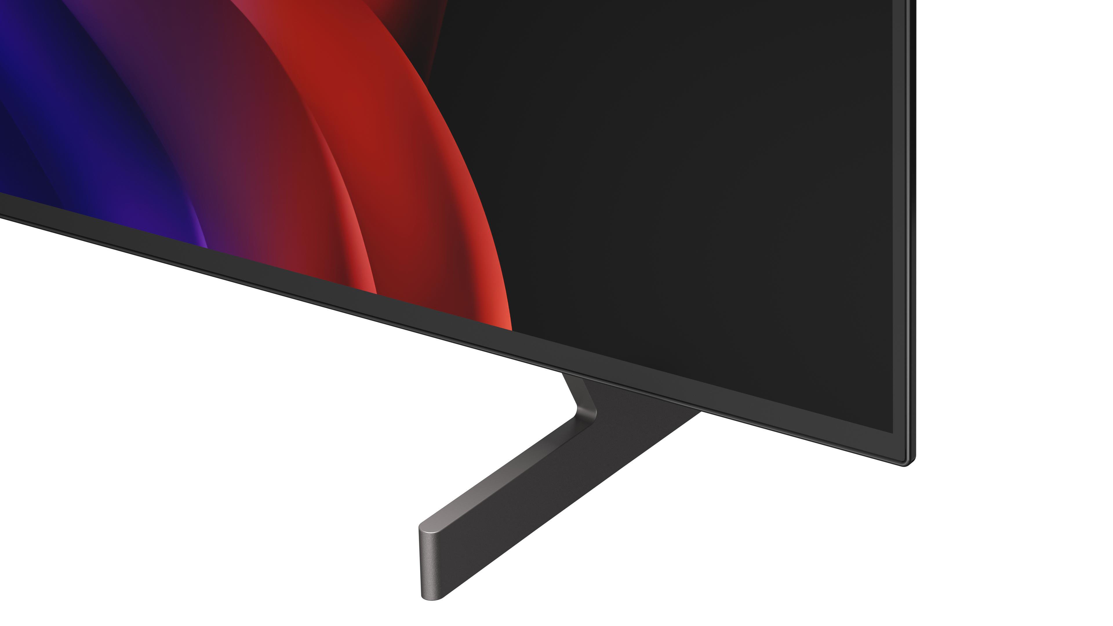 Nahaufnahme eines Fernsehers mit einem grauen Ständer und einem abstrakten Hintergrund.