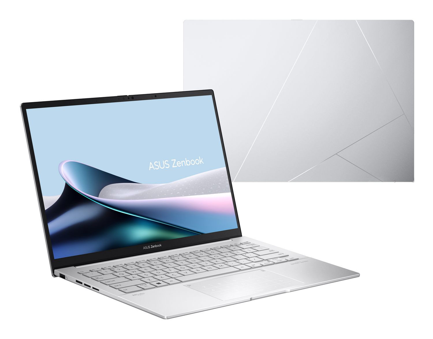 Un portátil plateado abierto con pantalla y teclado Zenbook iluminados.