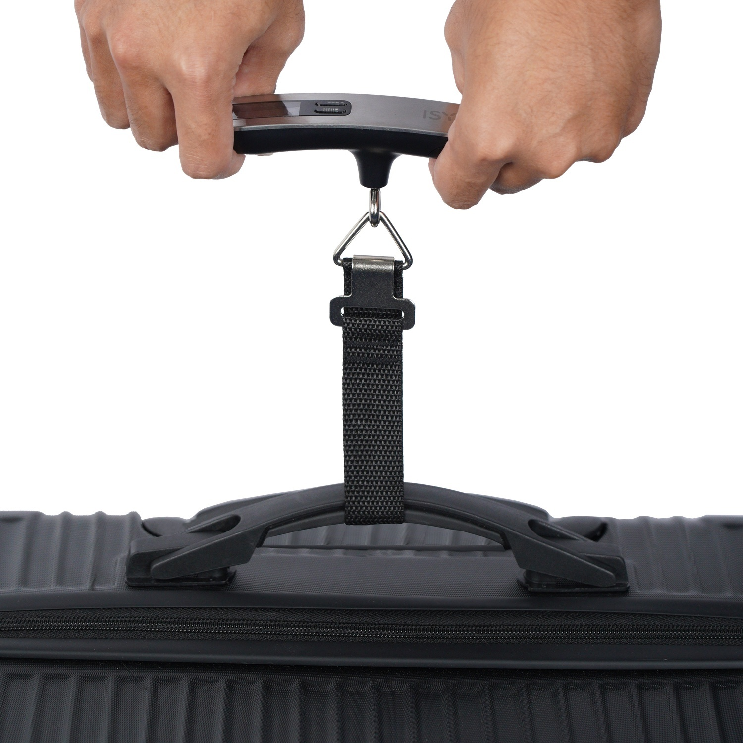 Hands holding a luggage scale hanging from a black suitcase.