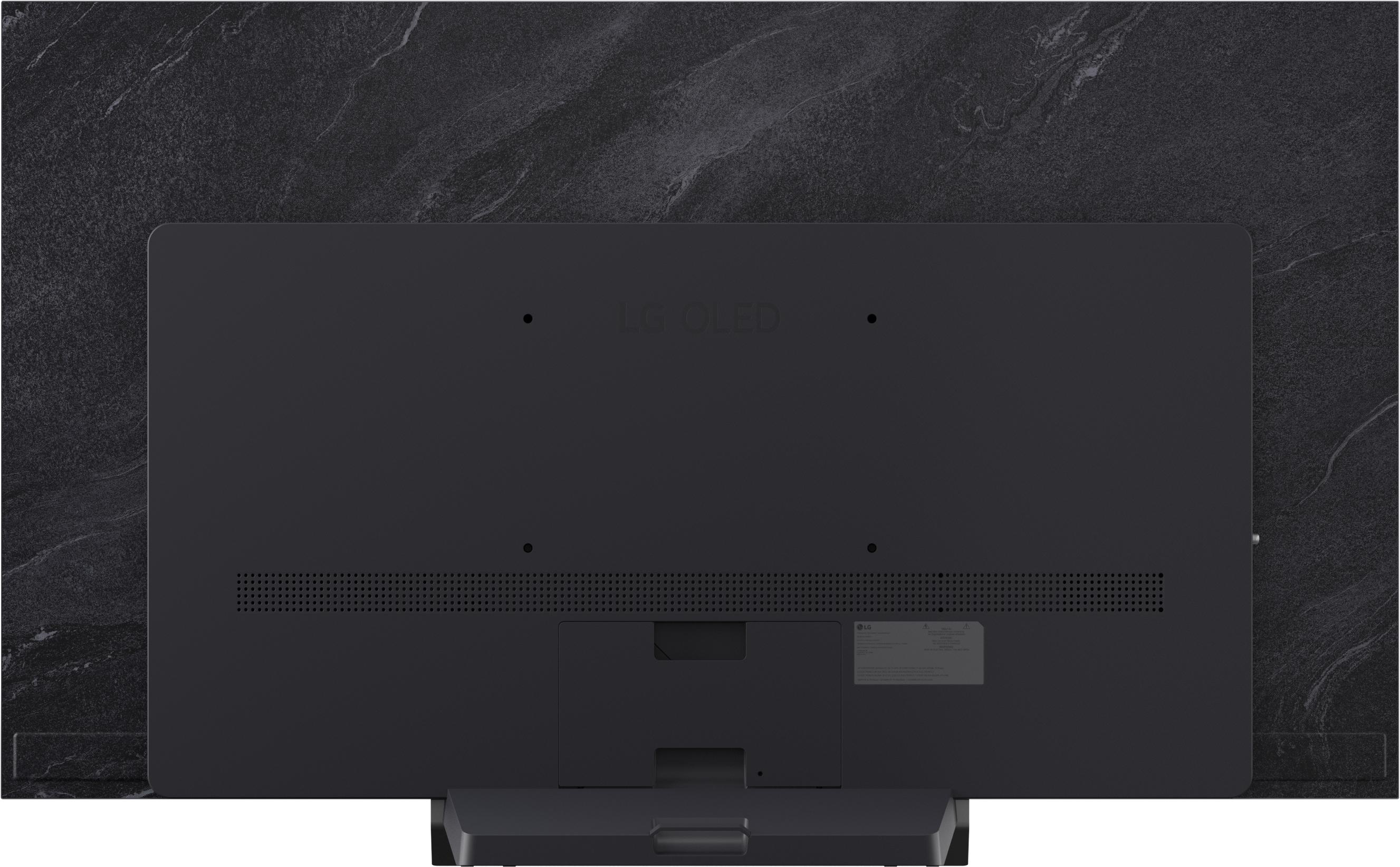 Rückseite eines schwarzen LG OLED Fernsehers mit dunklem Marmor Hintergrund.