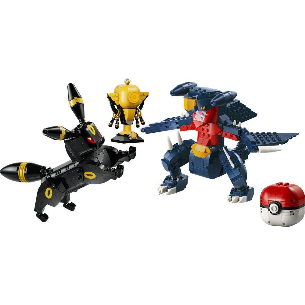 Ein schwarzer Pokémon-Charakter, ein goldener Pokal und ein blauer Drachen-Charakter.