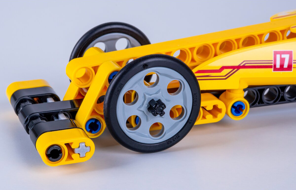 Egy sárga Lego autó fekete és szürke kerekekkel, 17-es számmal az oldalán.