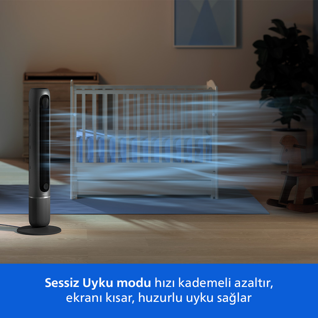 Yatak odasında, karyolanın önünde, hafif hava akımları gösteren bir kule vantilatör.