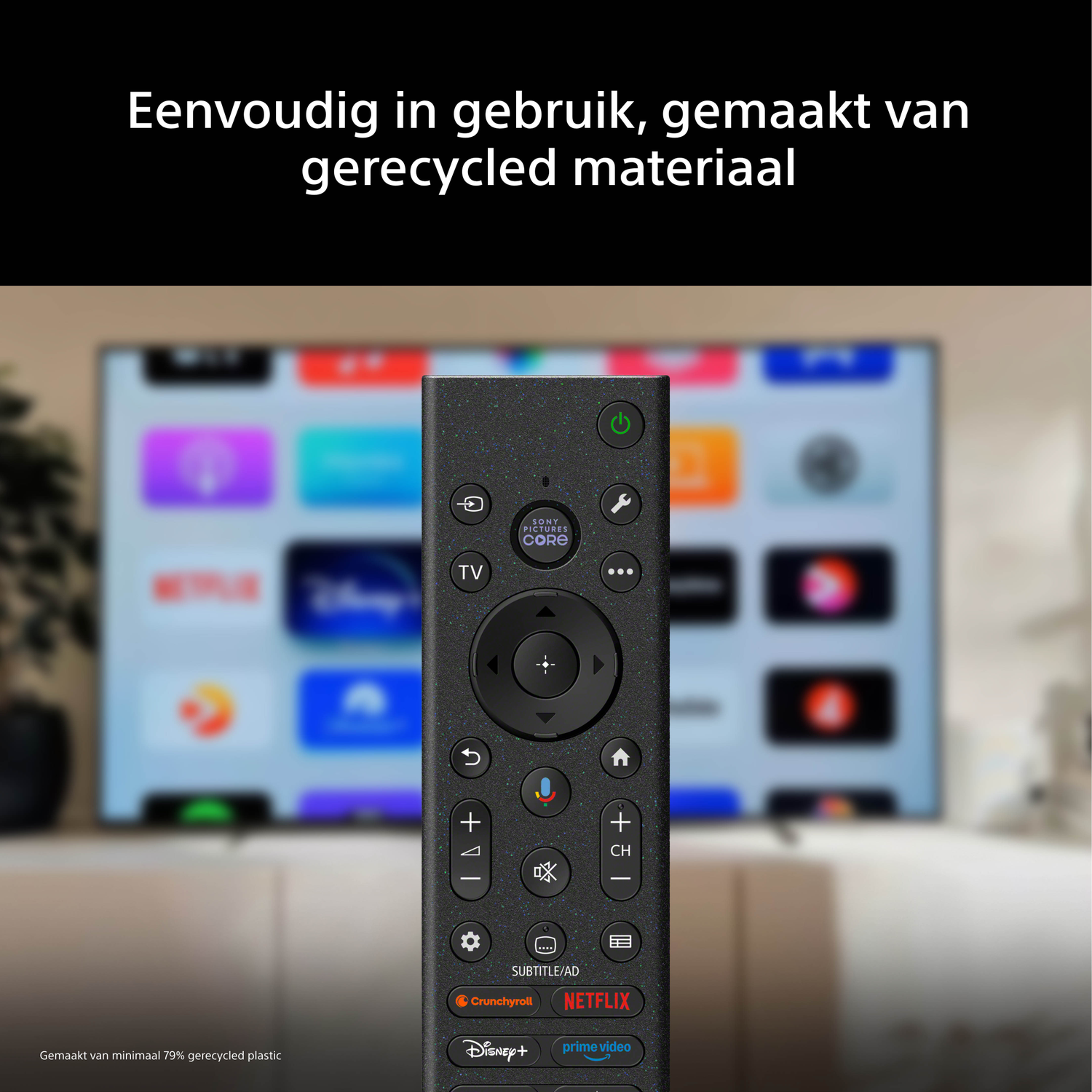 A modern TV remote in front of a blurred TV screen showing app icons.