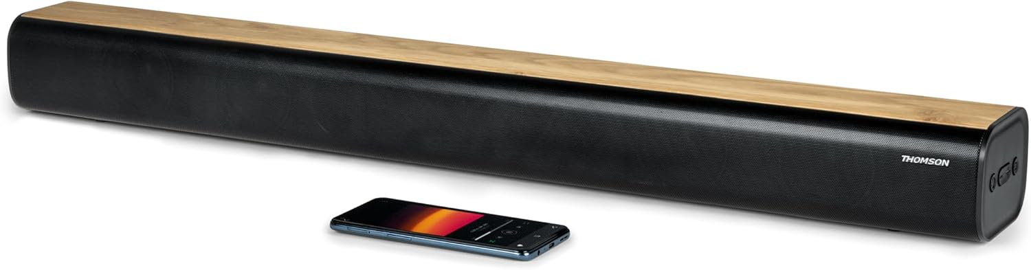 Barra de sonido negra con parte superior de madera y un smartphone delante.