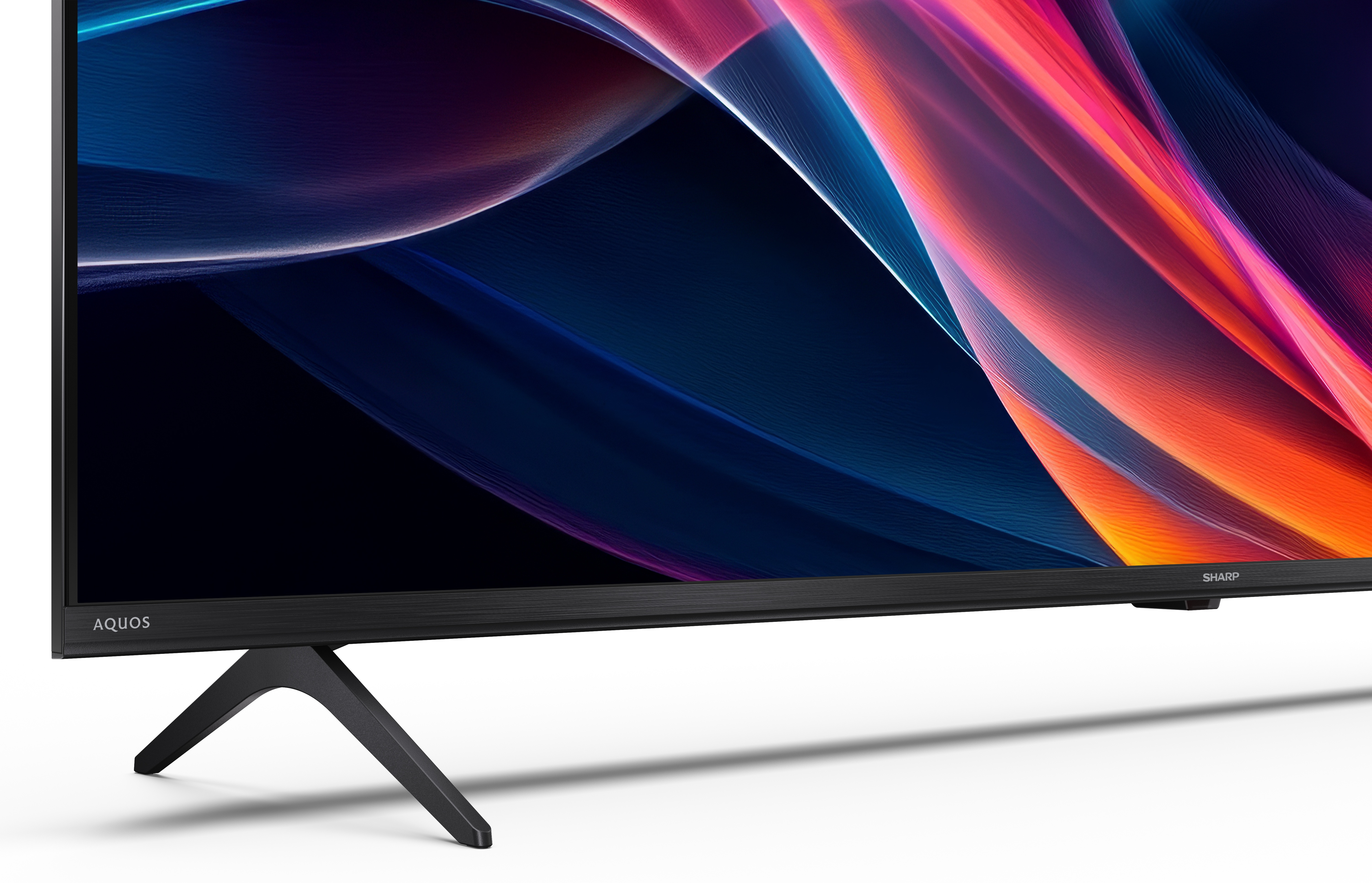 Czarny telewizor z kolorowym, abstrakcyjnym obrazem i podstawką.