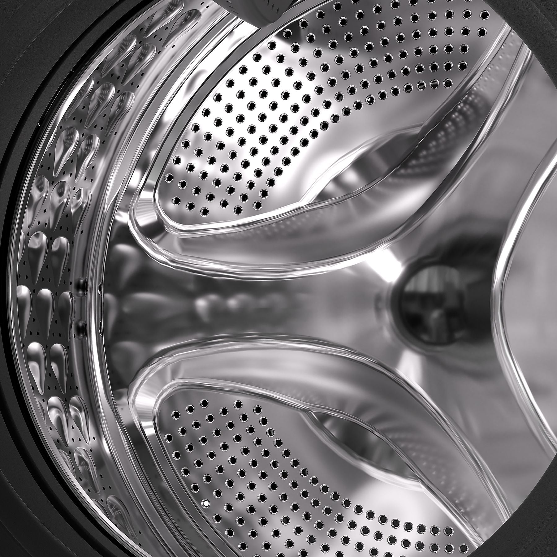 Vue intérieure d'un tambour de machine à laver argenté vide à motif perforé.