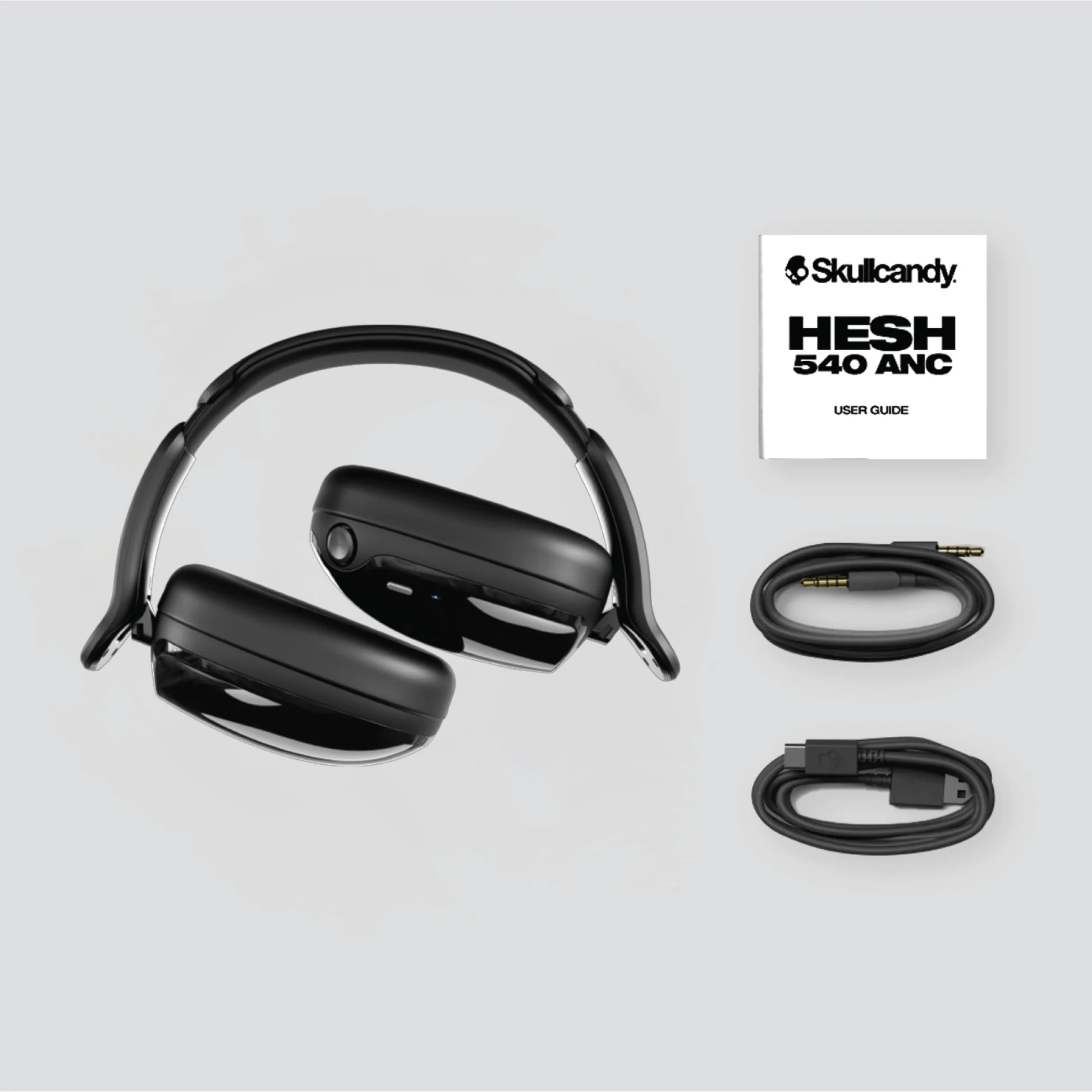 Fekete Skullcandy Hesh 540 ANC fejhallgató kábelekkel és kézikönyvvel.