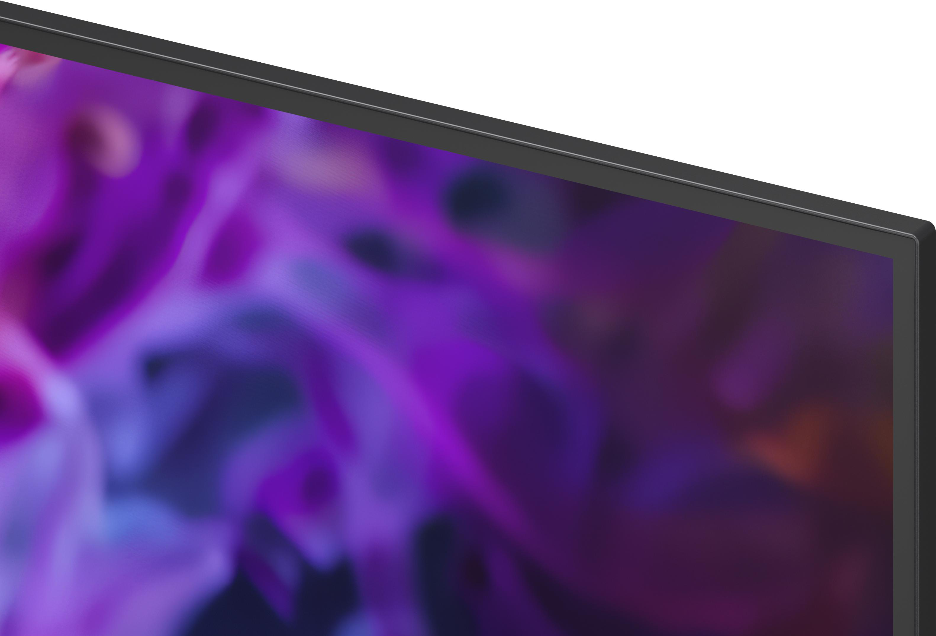 Ein Teil eines schwarzen Monitors mit einem lila und blauen abstrakten Hintergrund.