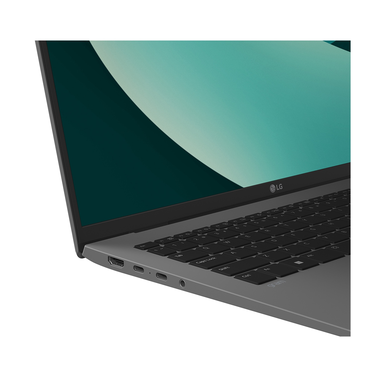 Primo piano di un laptop LG Gram grigio, che mostra tastiera e porte. Schermo turchese sullo sfondo.