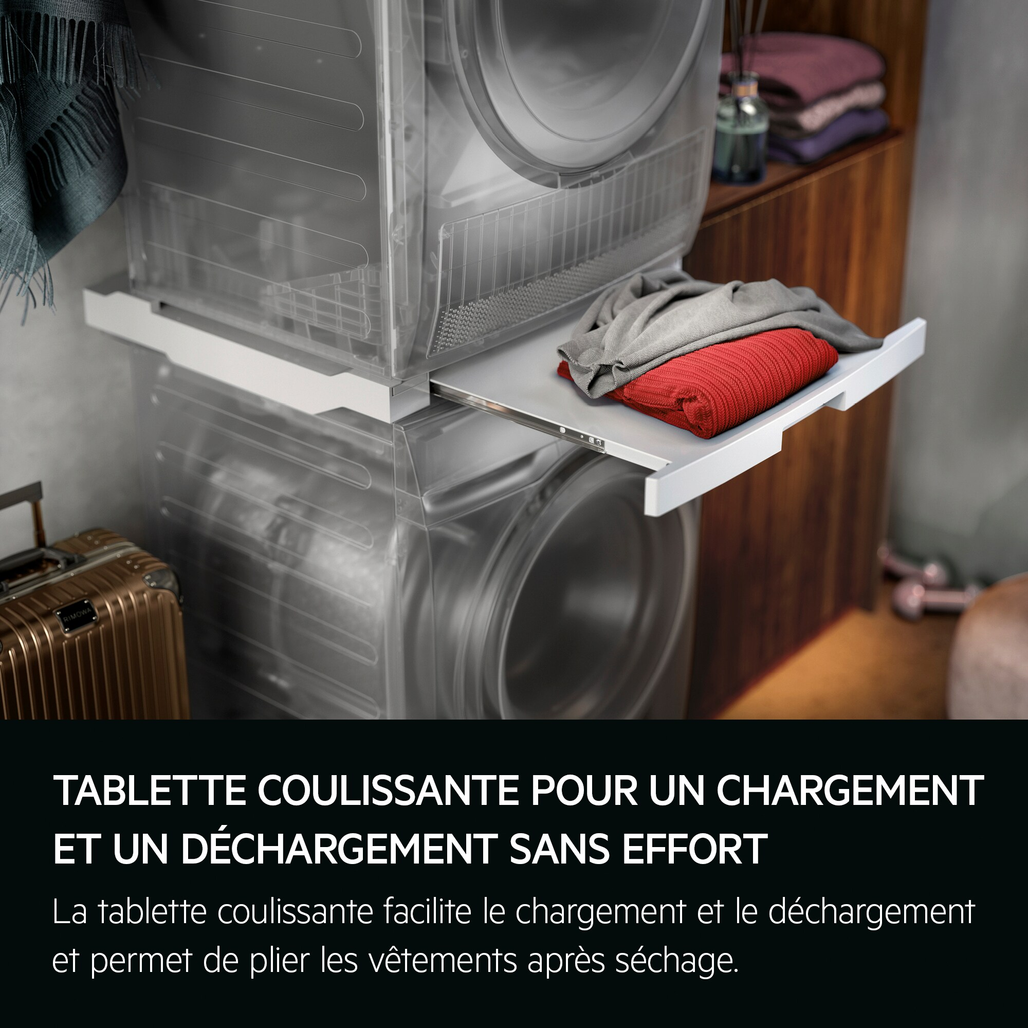 Sèche-linge avec tablette coulissante chargée de linge. Valise à gauche.