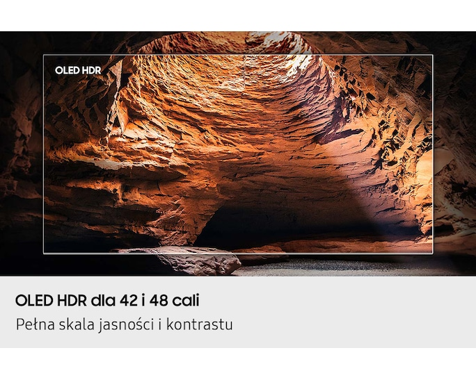 Telewizor OLED HDR pokazuje jaskinię z czerwonymi skałami i promieniami światła.