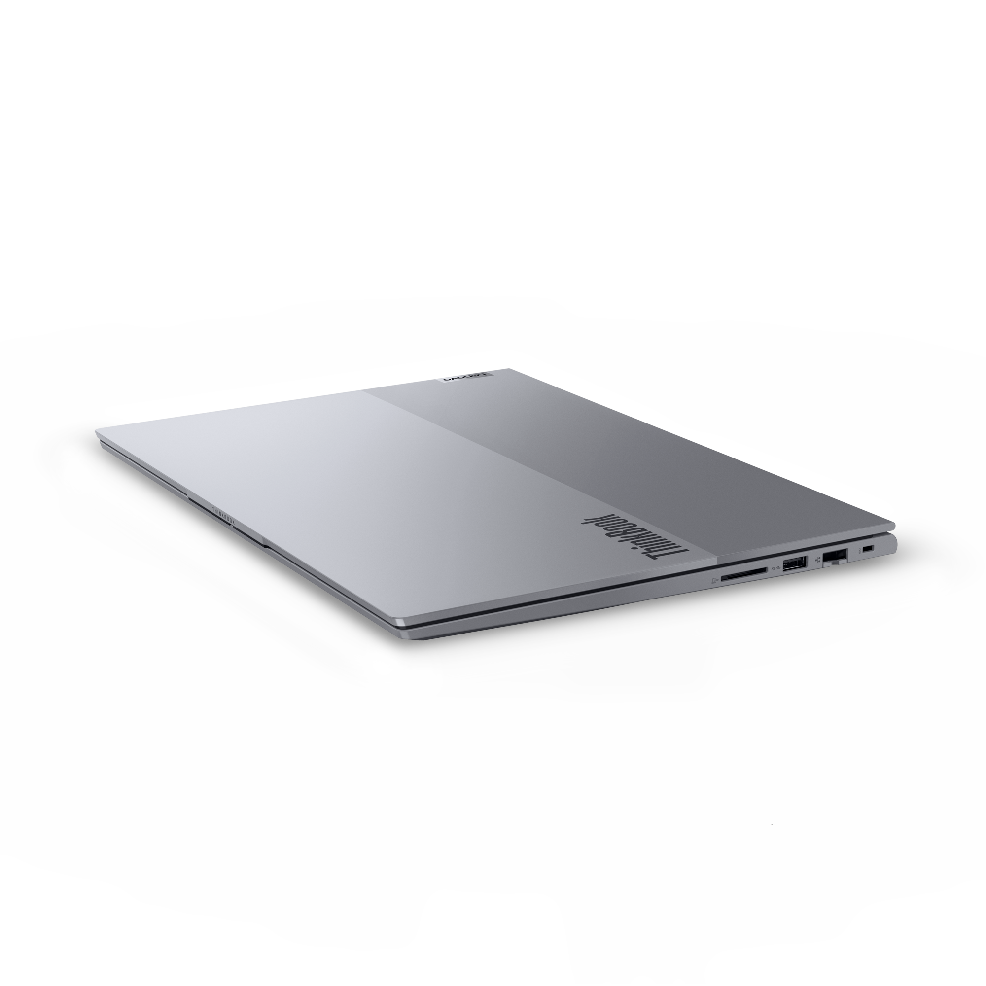 Zamknięty srebrny laptop Lenovo ThinkBook na czarnym tle.