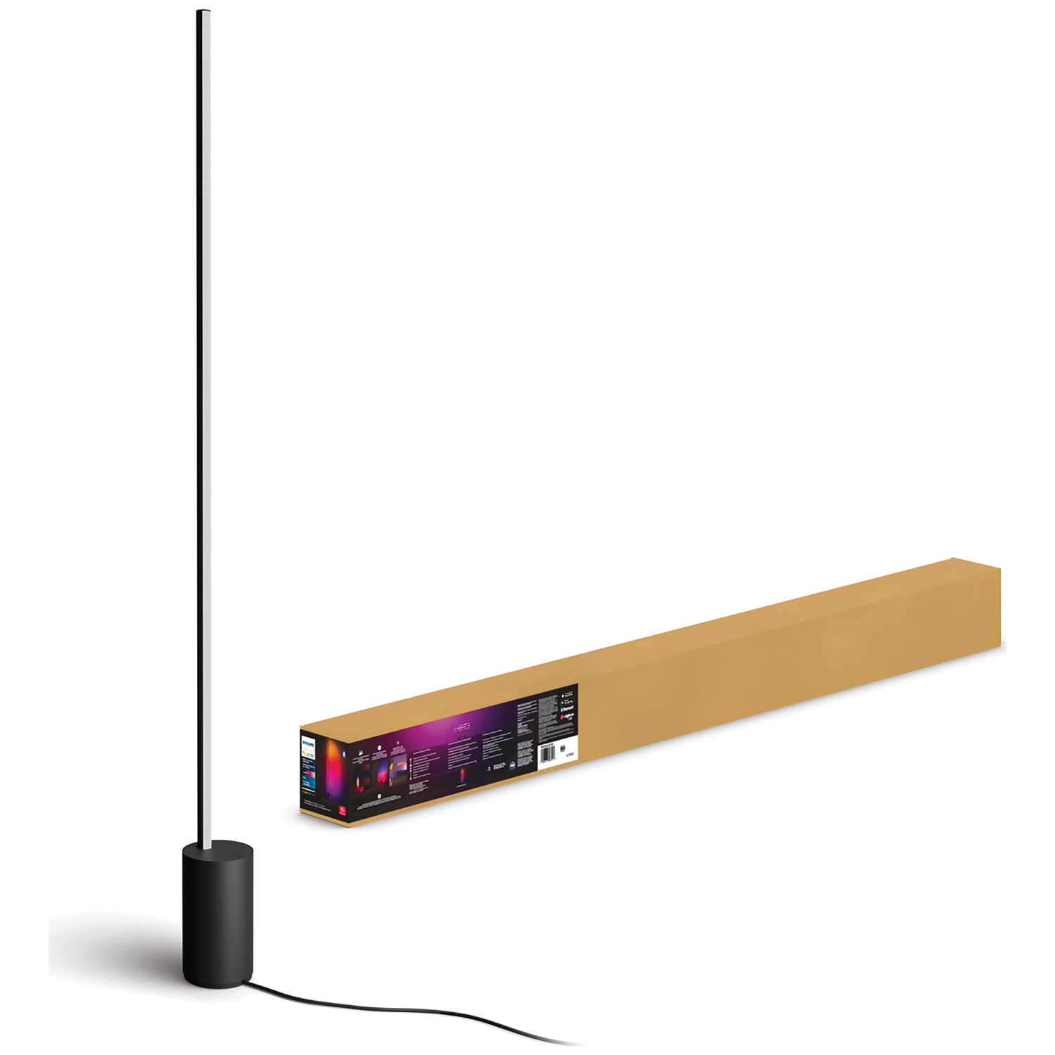 Zwarte staande lamp met slanke paal en cilindrische voet naast een kartonnen doos.