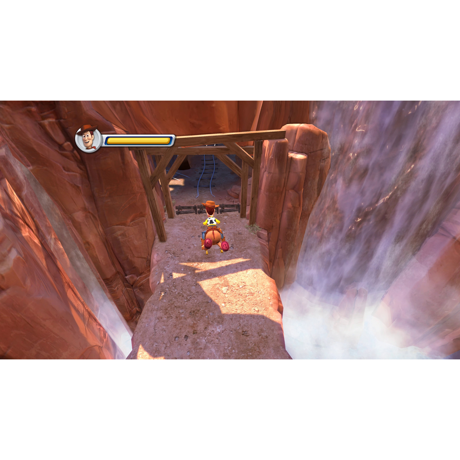 Woody op een smal pad boven een waterval, met een houten brug.