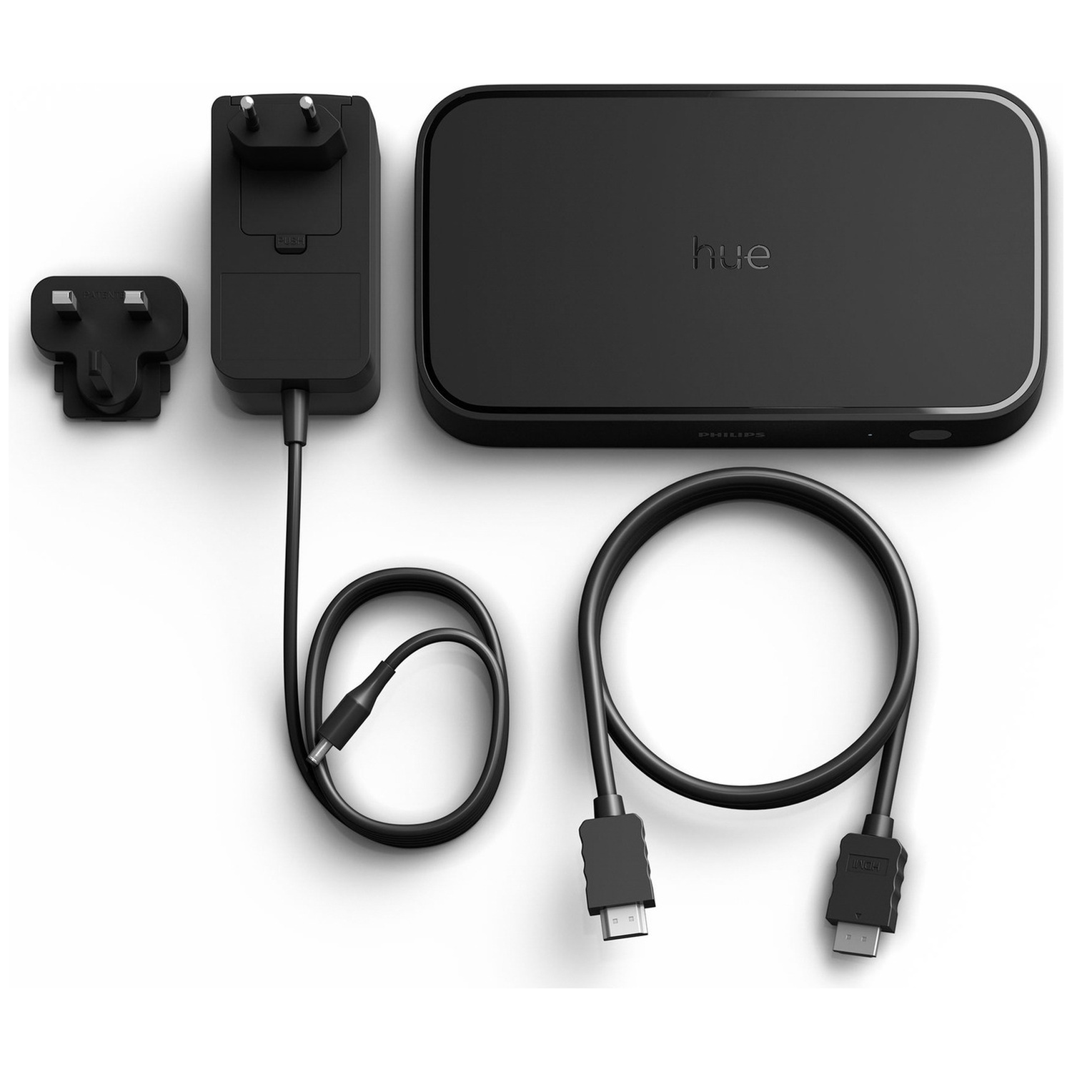 Zwarte Philips Hue Sync Box met stroomadapter, Britse stekkeradapter en HDMI-kabel.