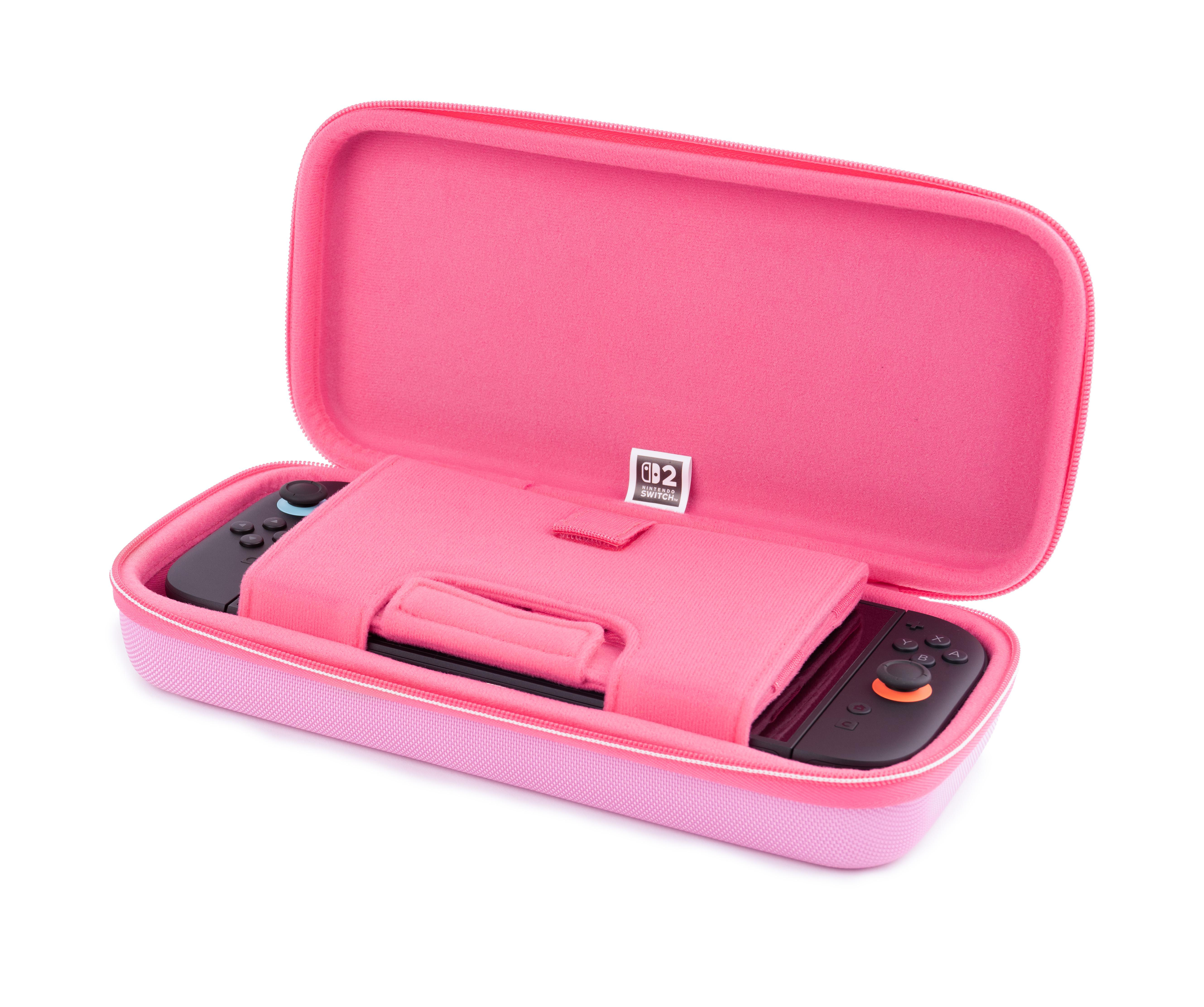 Ein pinker Koffer mit einem Nintendo Switch und Controllern.