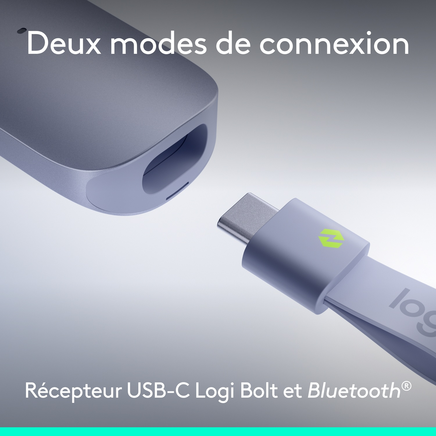 Un dongle USB-C gris avec logo Logitech et un récepteur en gros plan.