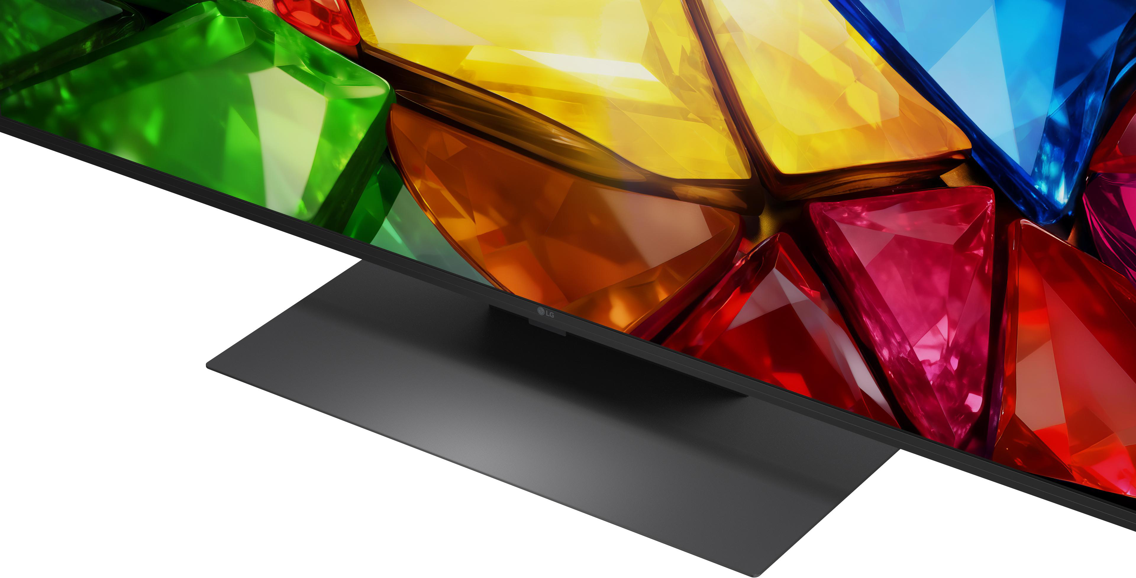 LG TV-Bildschirm zeigt bunte, facettierte geometrische Formen in Grün, Gelb, Orange und Rot.