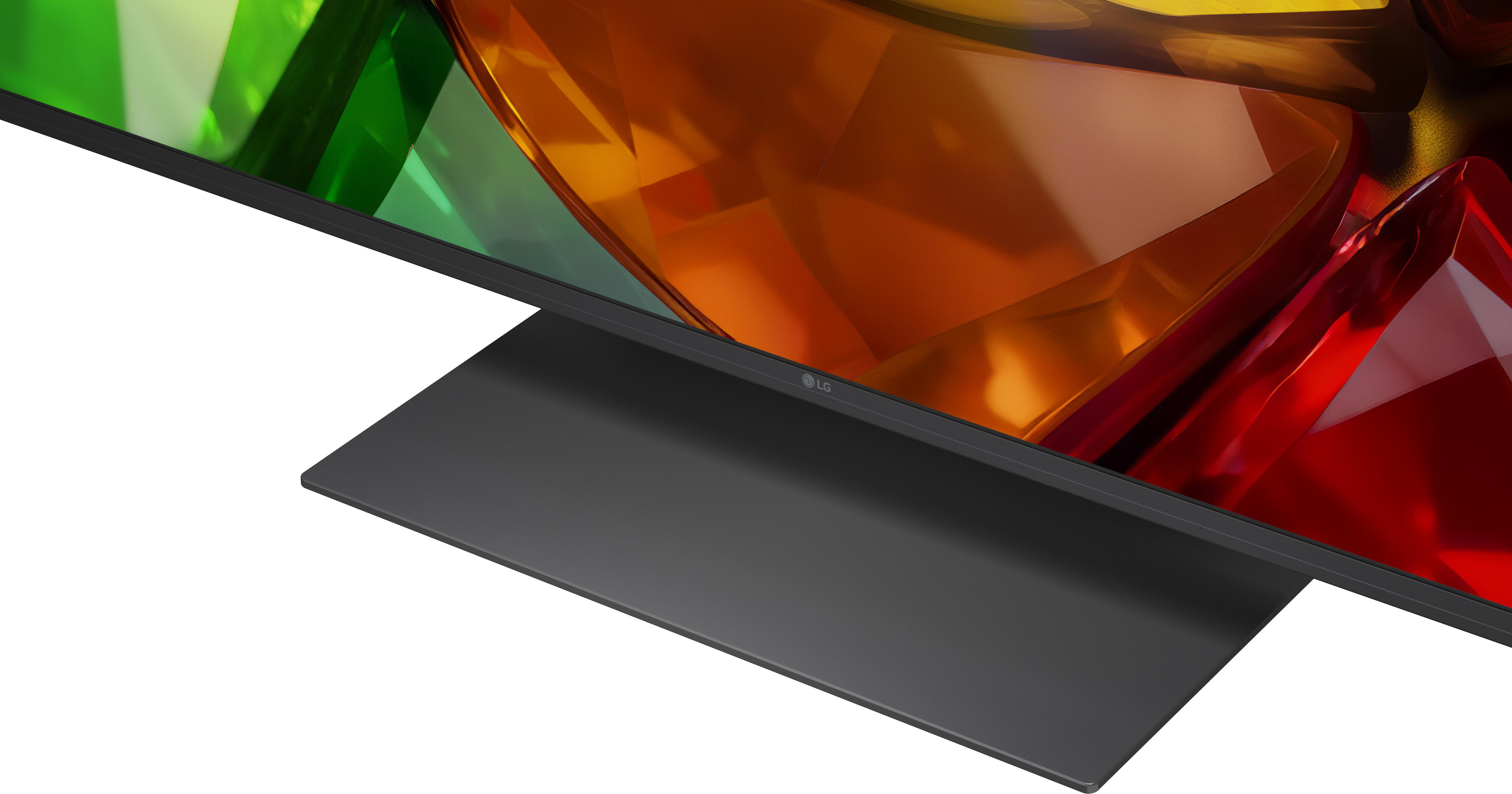 Nahaufnahme eines modernen Fernsehers mit schwarzem Standfuß und lebendigem, facettenreichem Bildschirminhalt.