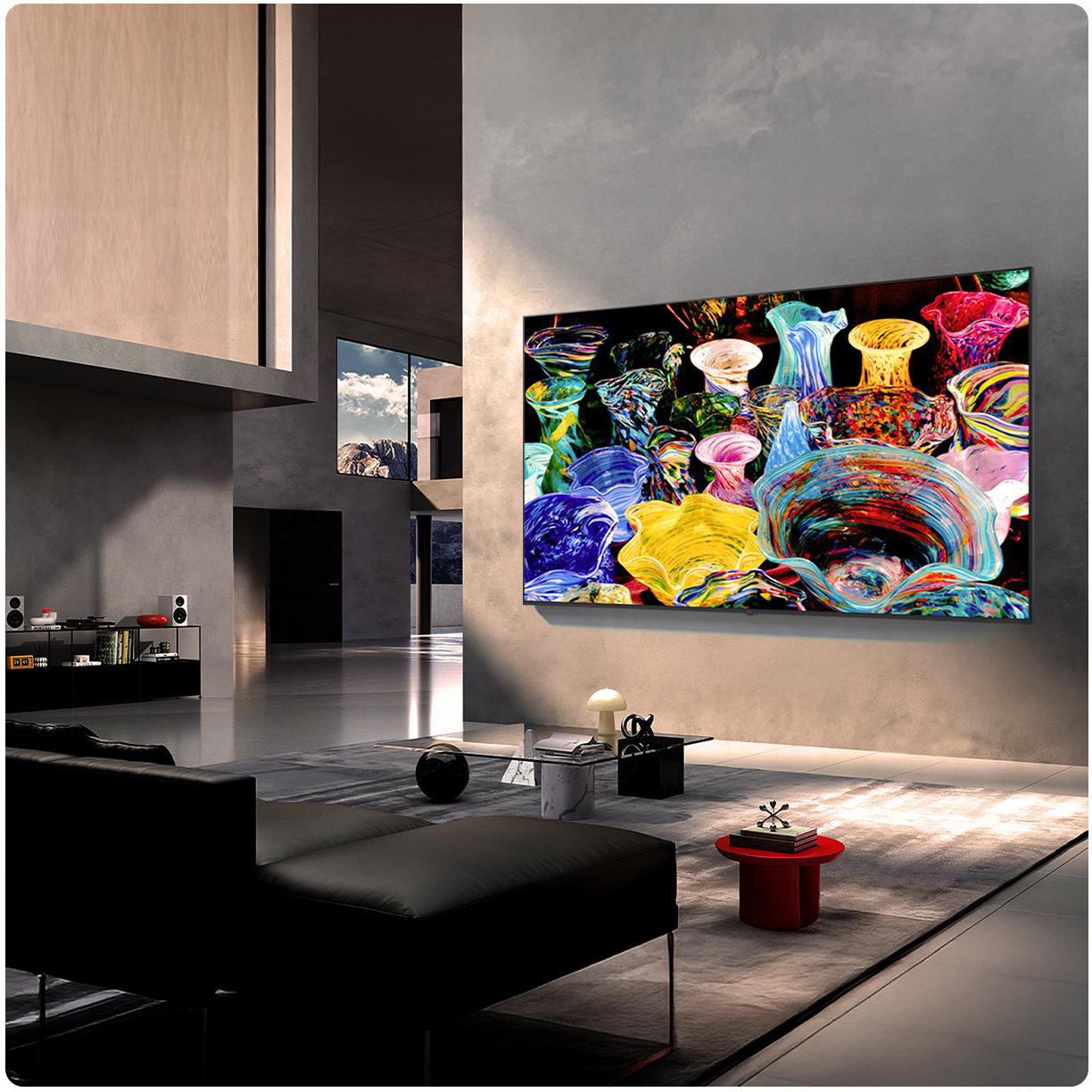 Ein modernes Wohnzimmer mit einem großen, farbenfrohen Kunstwerk auf dem Fernseher.