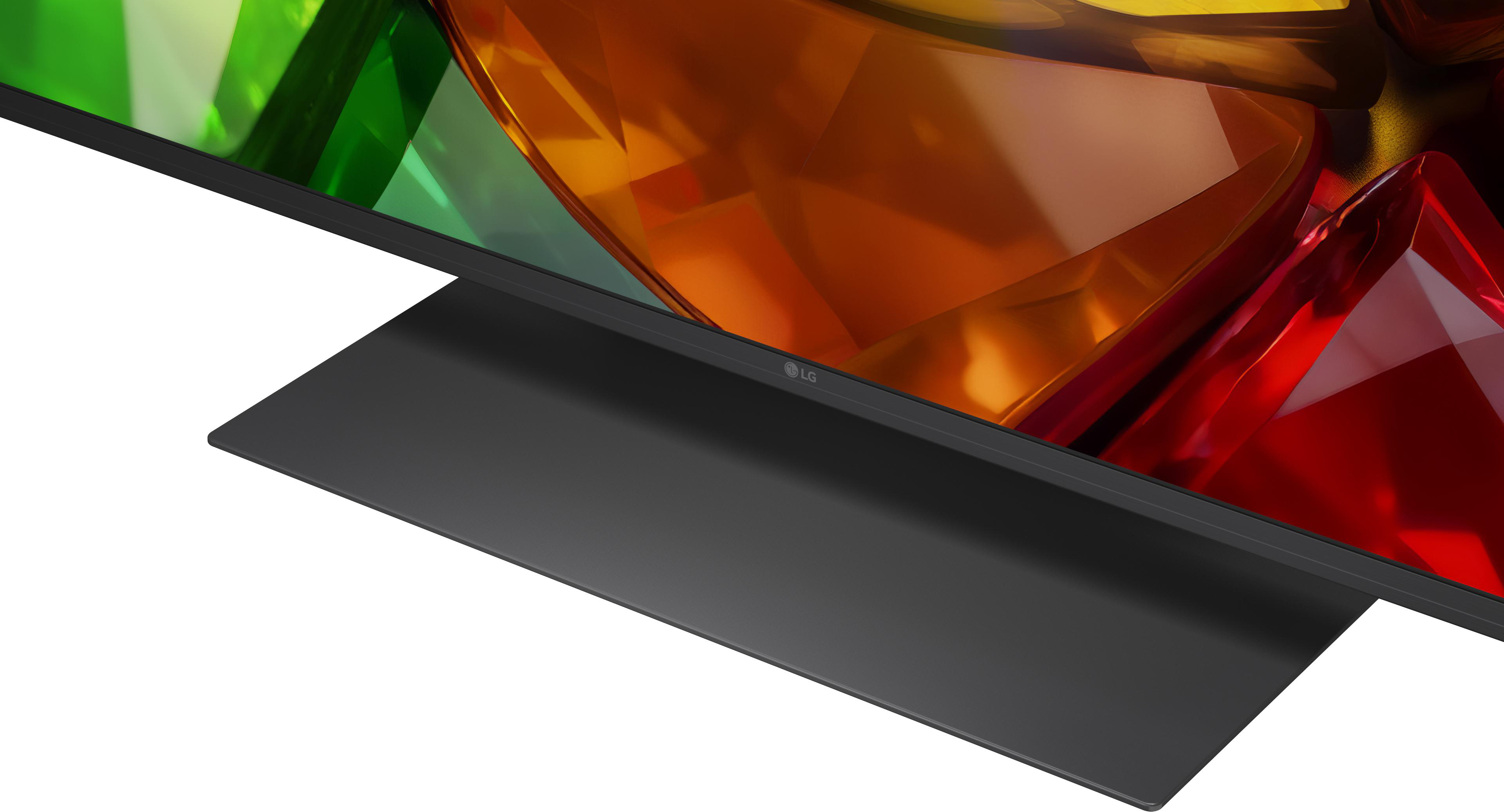 Nahaufnahme eines schwarzen LG TV-Ständers mit bunten, abstrakten Bildschirm.