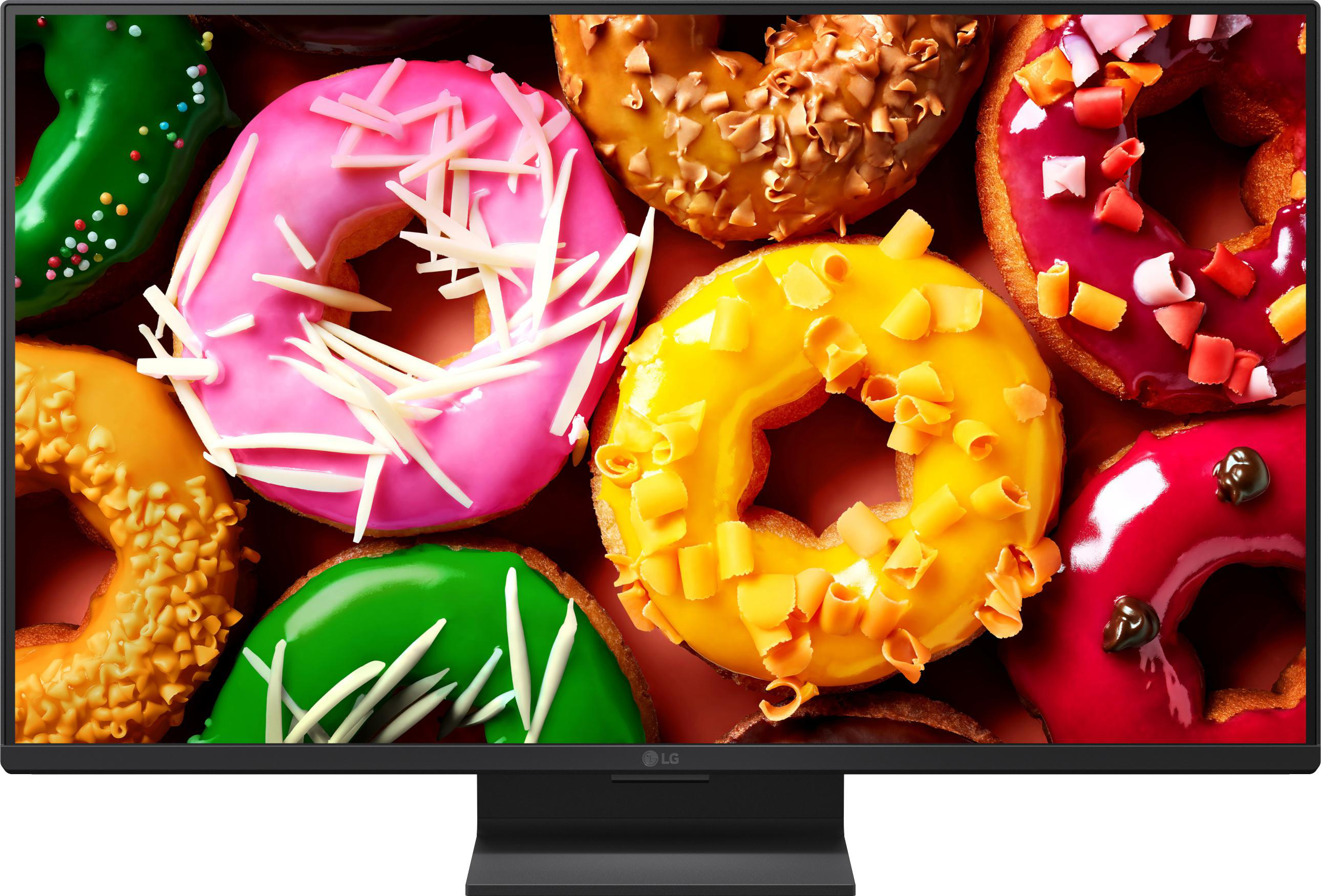 Bunte Donuts mit Zuckerguss und Streuseln auf einem dunklen Hintergrund.