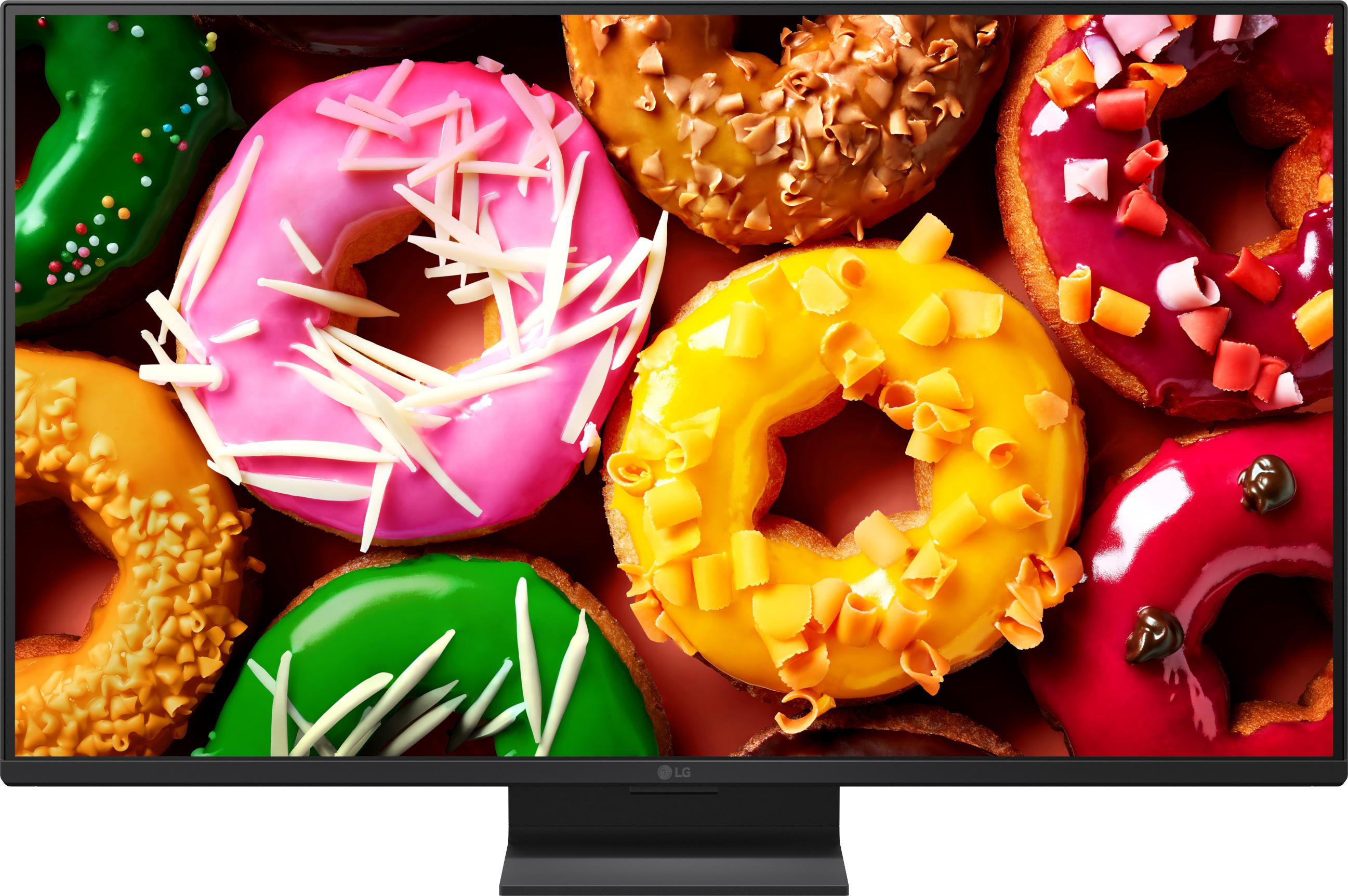 Nahaufnahme von bunten, glasierten Donuts mit Streuseln und Schokostückchen.