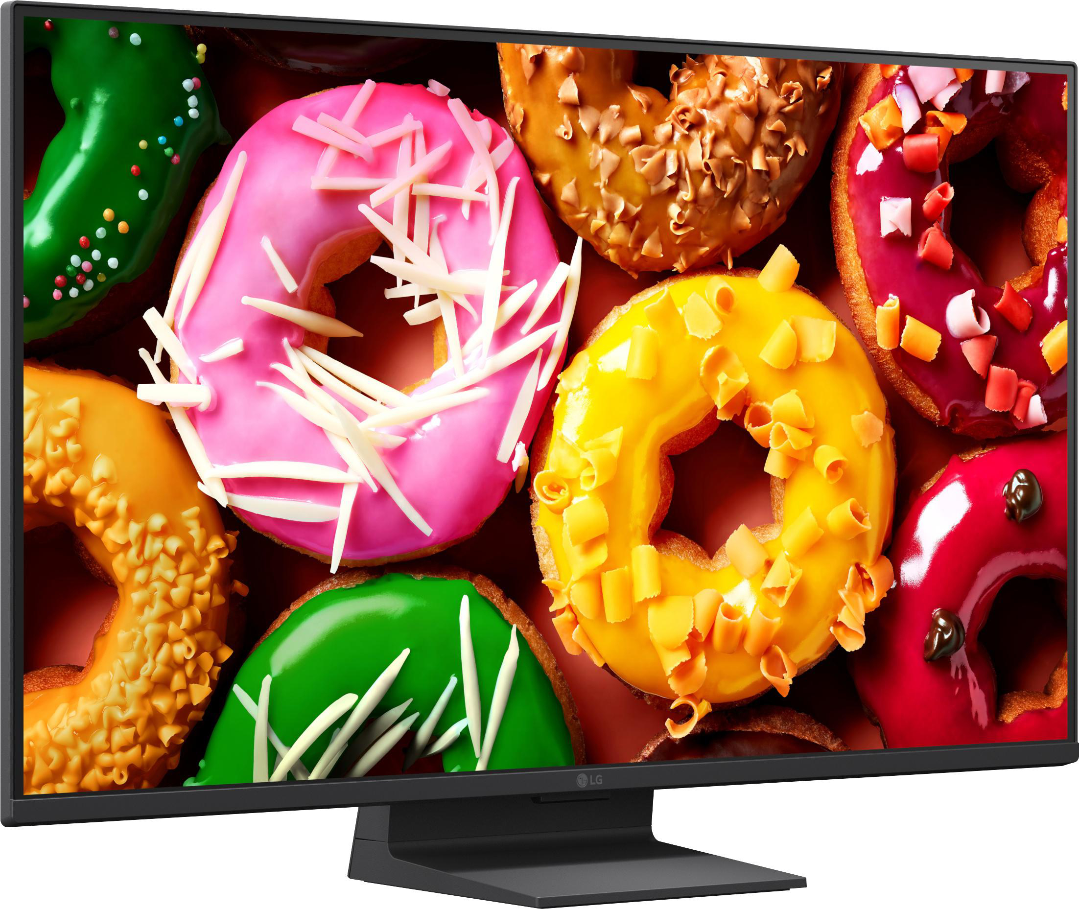 Bunter Haufen von Donuts mit Zuckerguss und Streuseln, Nahaufnahme.
