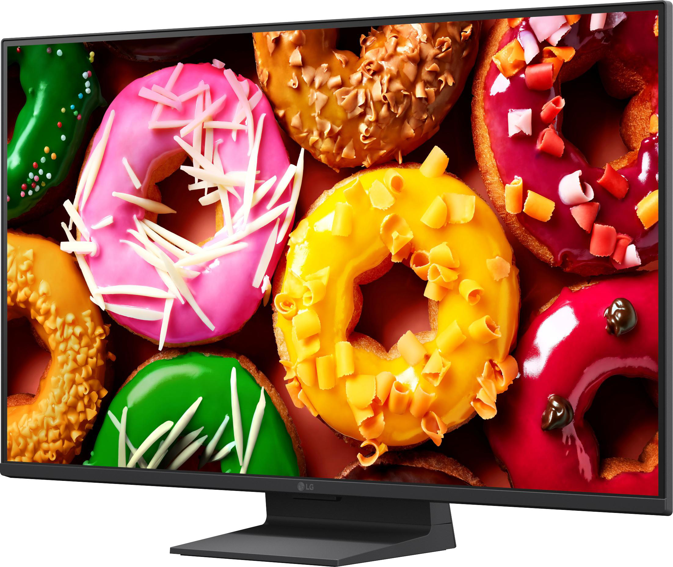 Bunte Glasierte Donuts mit Streuseln und Schokostückchen auf einem dunklen Hintergrund.