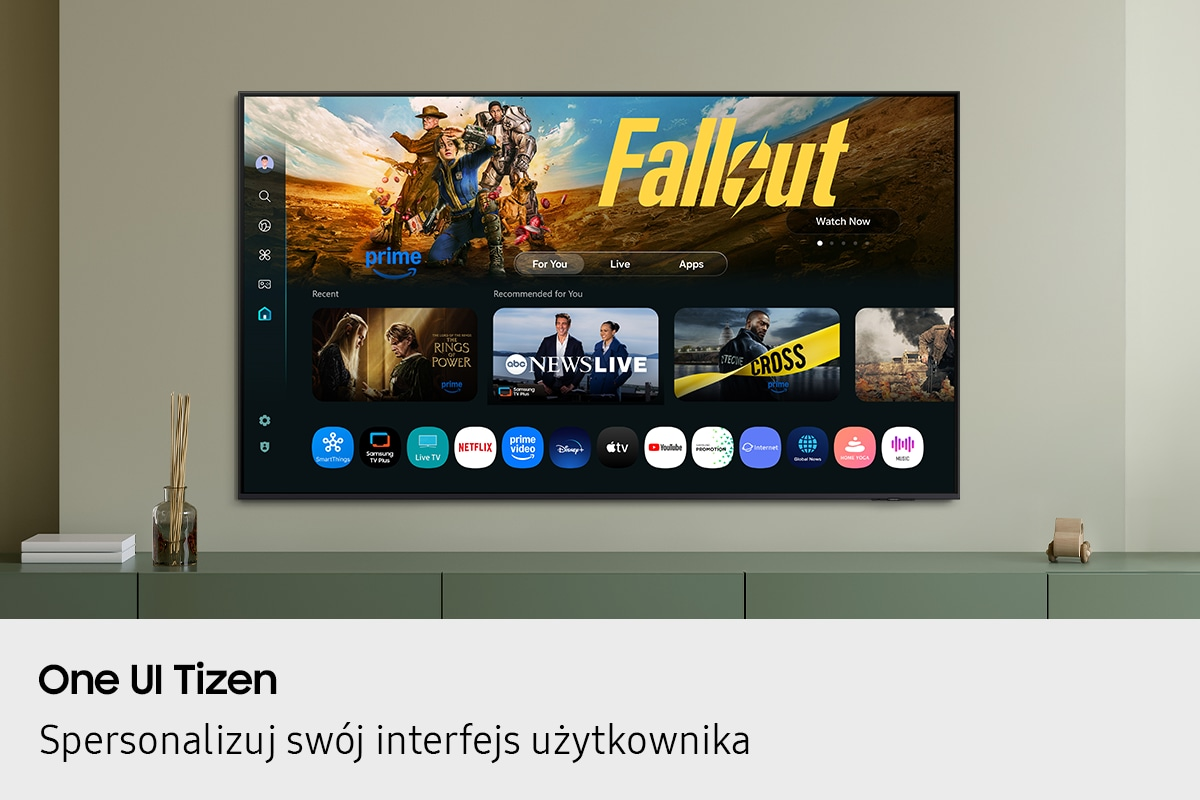 Ekran telewizora Smart TV wyświetla interfejs użytkownika Tizen z ikonami aplikacji i podglądami treści.
