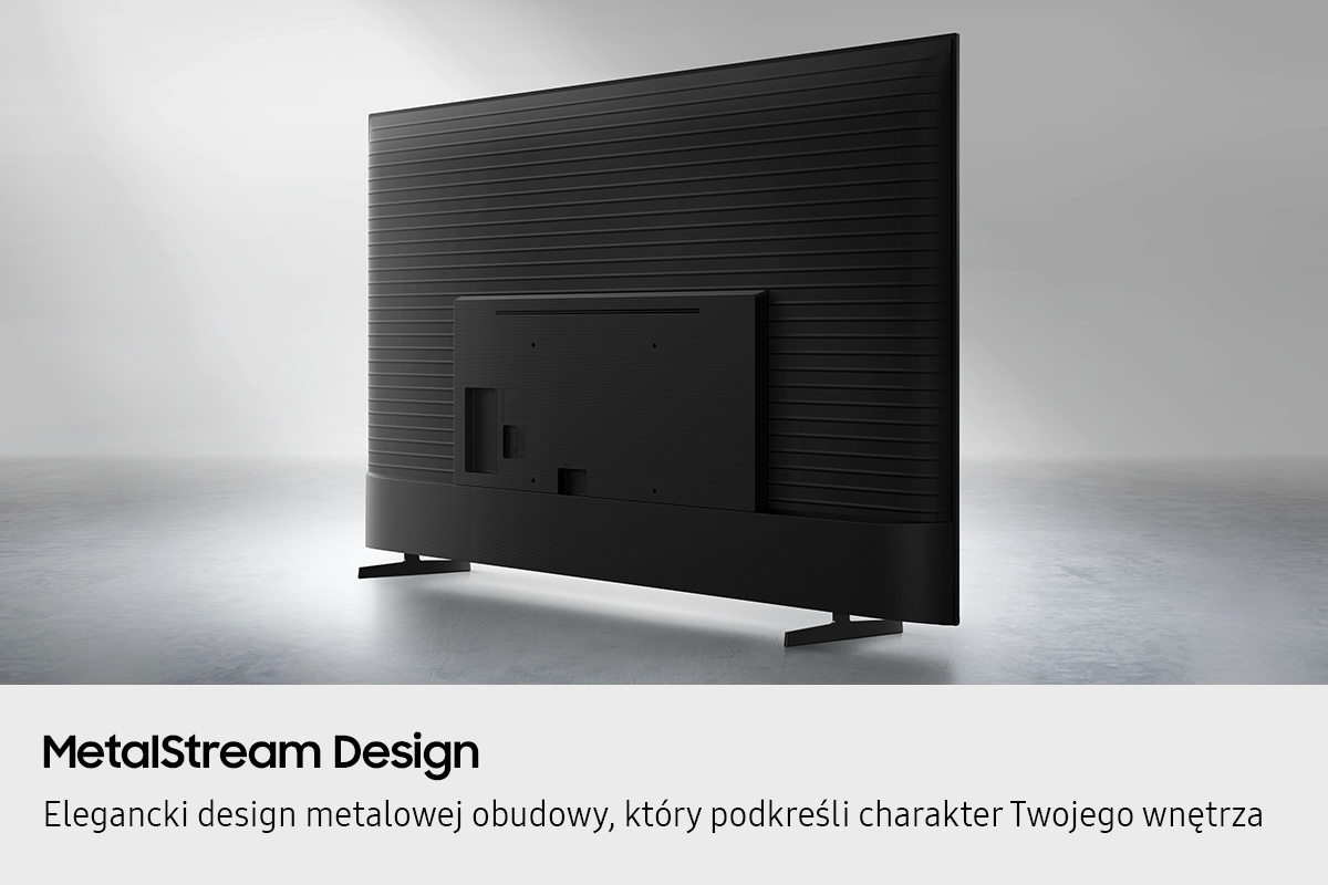 Tył czarnego telewizora z żebrowanym wzorem na szarej podłodze.