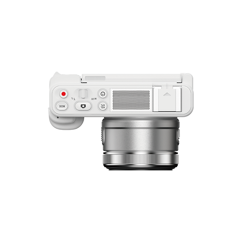 Üstten görünüm beyaz kamera, gümüş lens. Kontroller ve hoparlör ızgarası görünür.