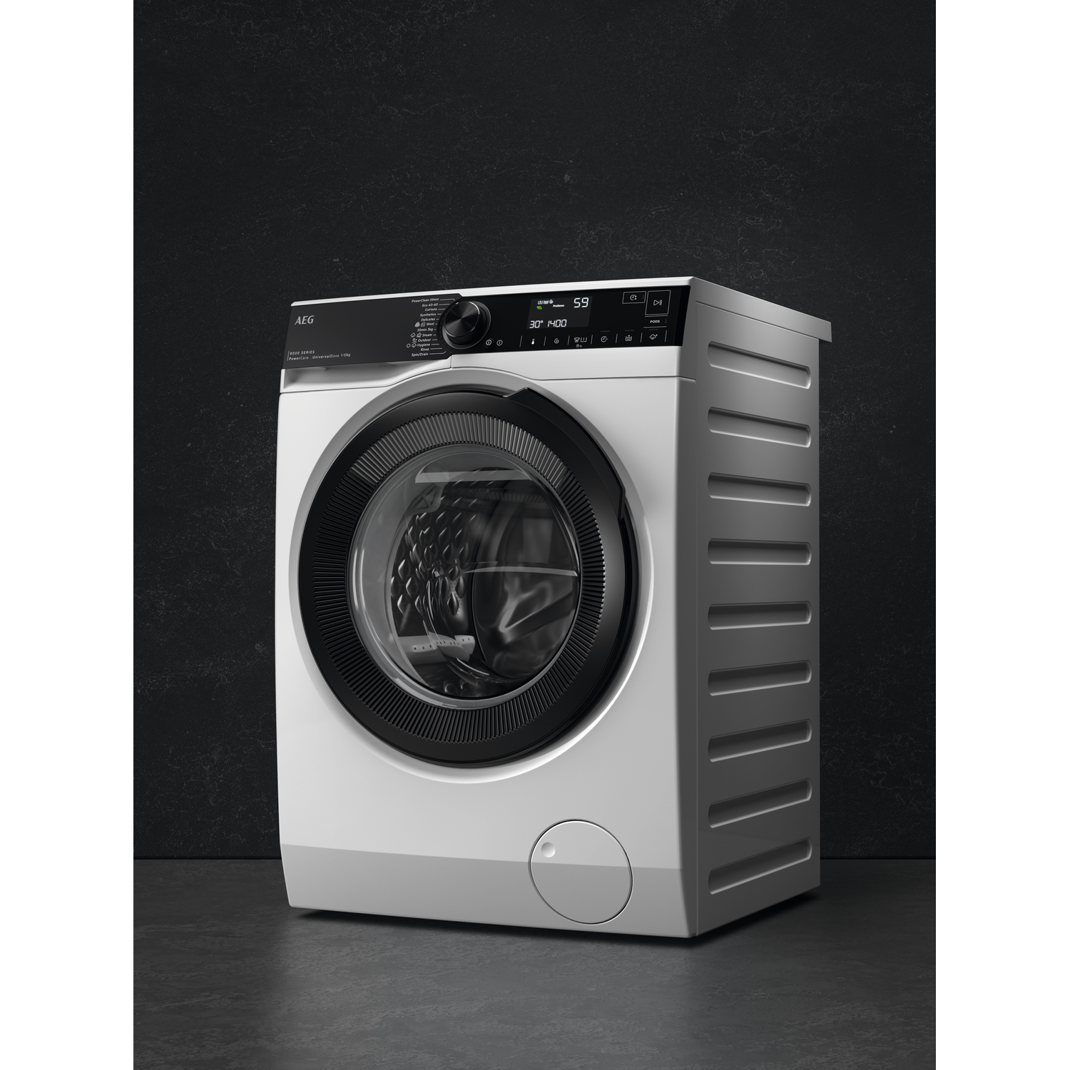Een witte wasmachine met zwarte deur en digitaal display staat op een donkere vloer.