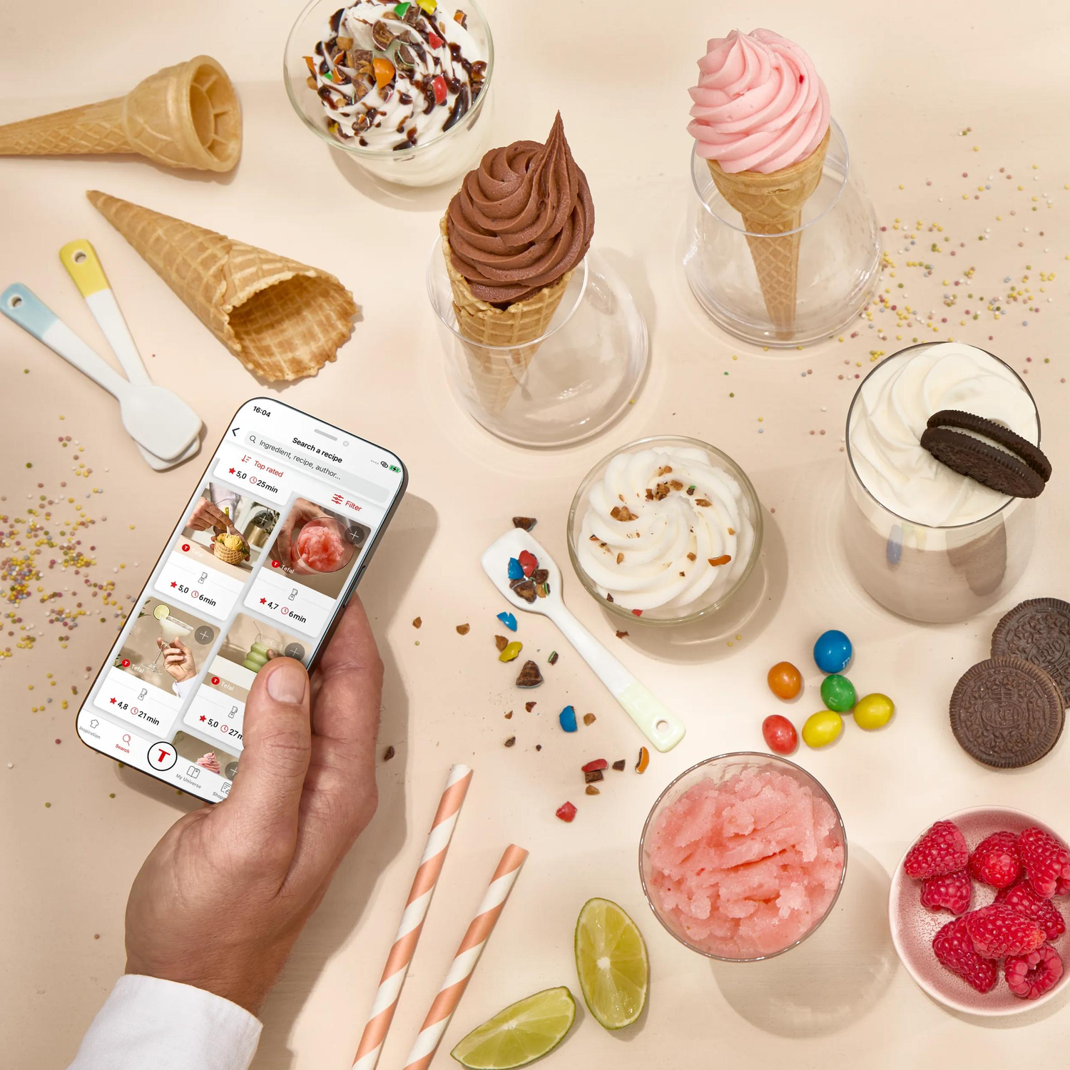Ice cream, cones, fruit, and a phone with recipes on a light background.