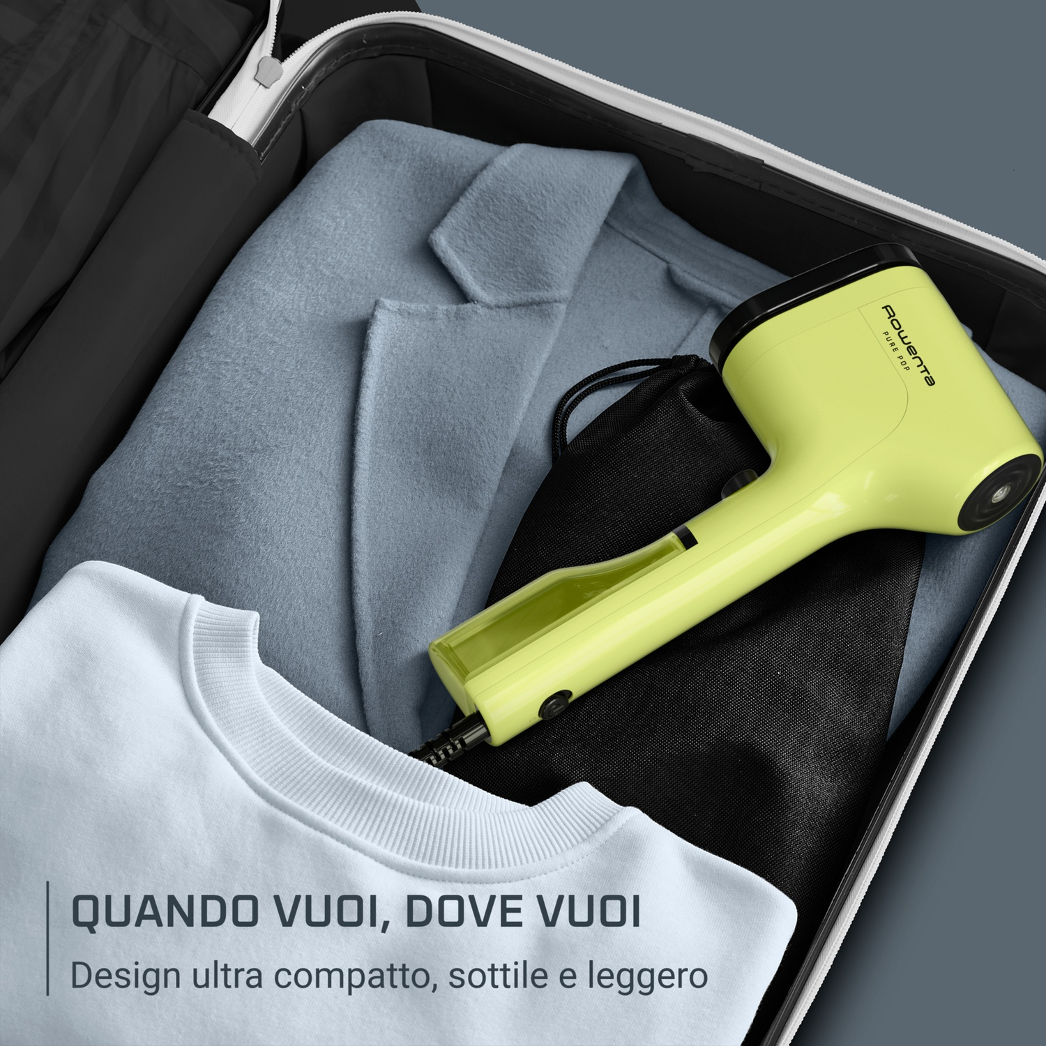 Un ferro da stiro a mano verde chiaro dentro una valigia con vestiti.