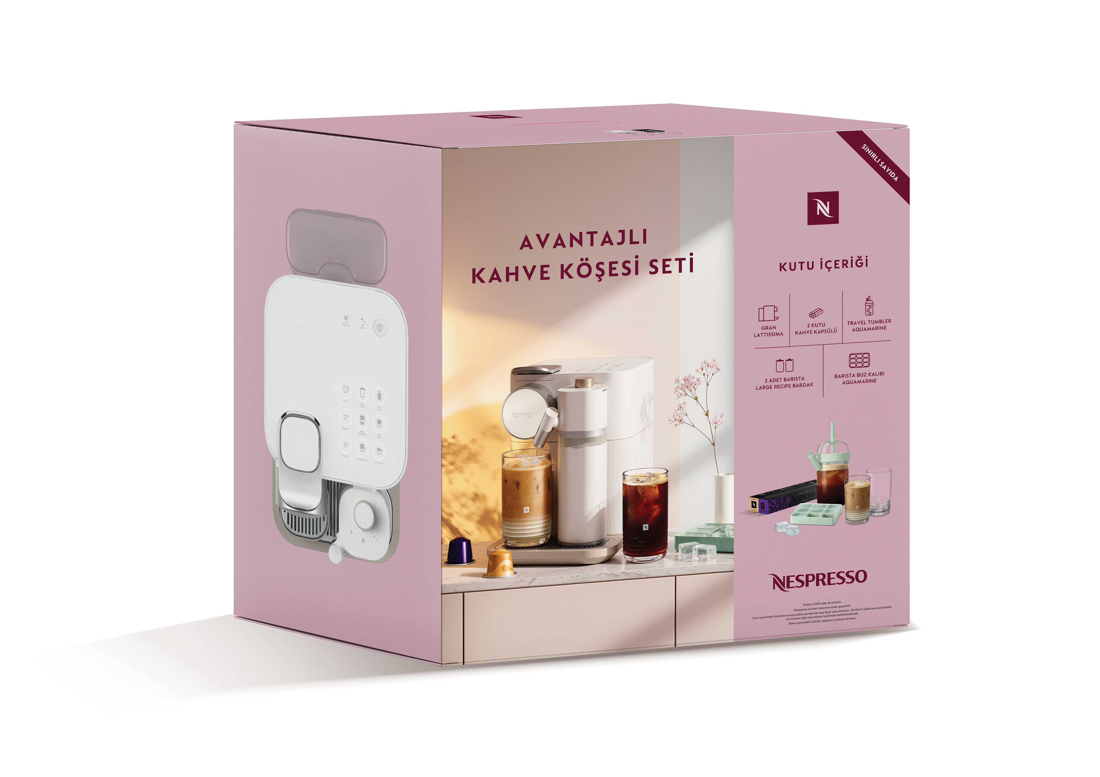 Kutu, iki bardak ve aksesuarlarla birlikte bir Nespresso kahve makinesi sergiliyor.