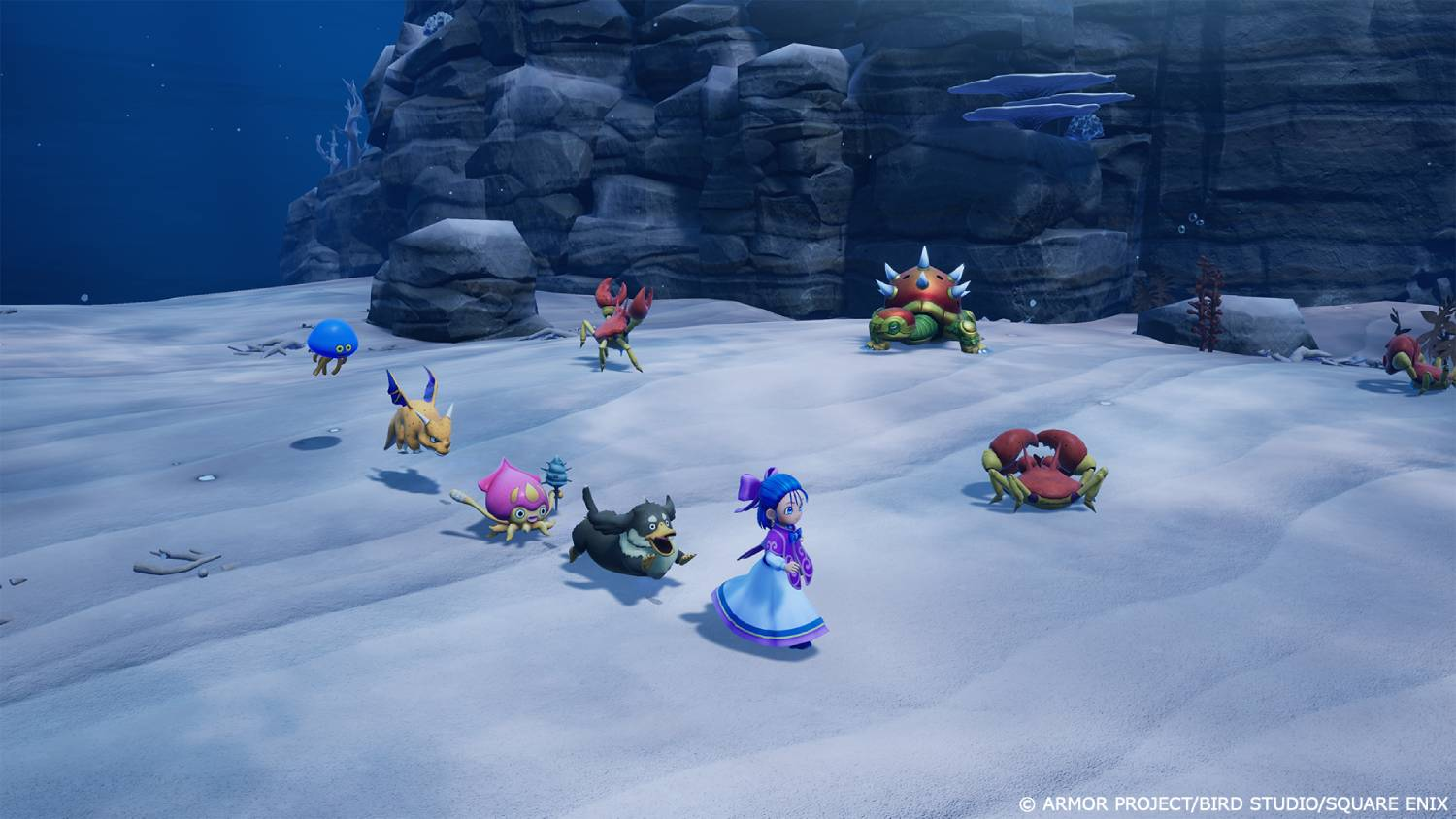 Un grupo de criaturas en el fondo de un océano helado con rocas al fondo.