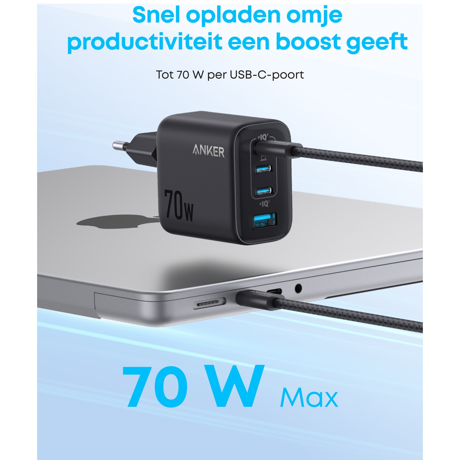 Black Anker 70W multi-port charger is charging a laptop.