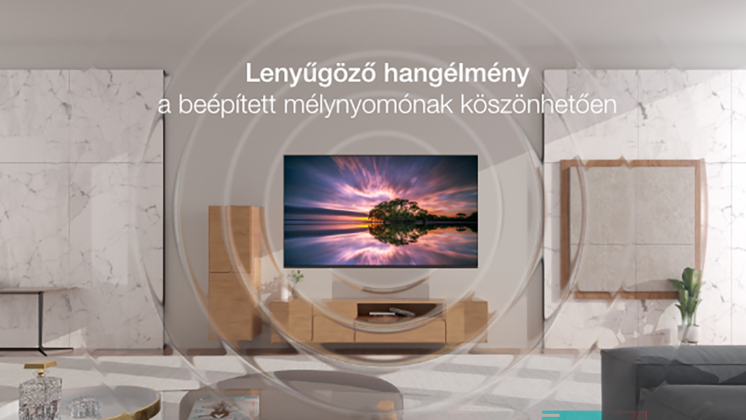 Modern nappali TV-vel, amely drámai naplementét mutat a víz felett.