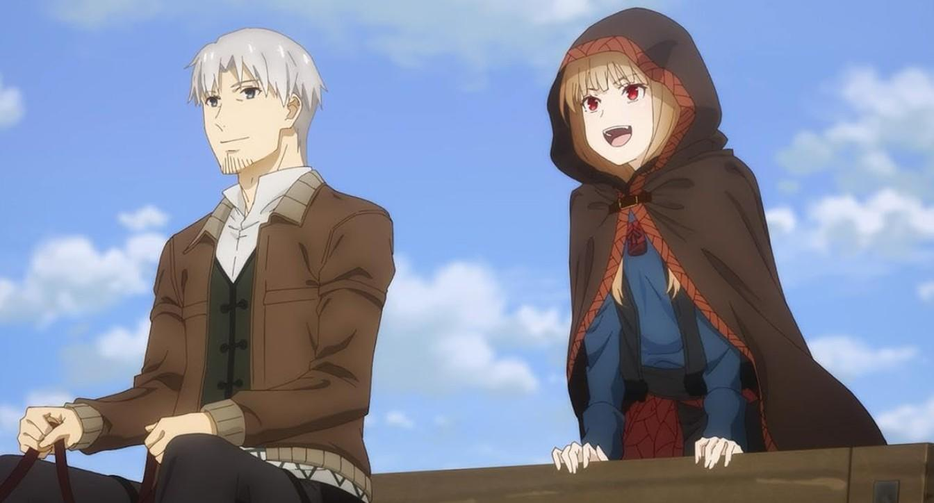 Ein Mann mit grauem Haar und eine Frau mit Kapuze blicken nach rechts vor blauem Himmel.