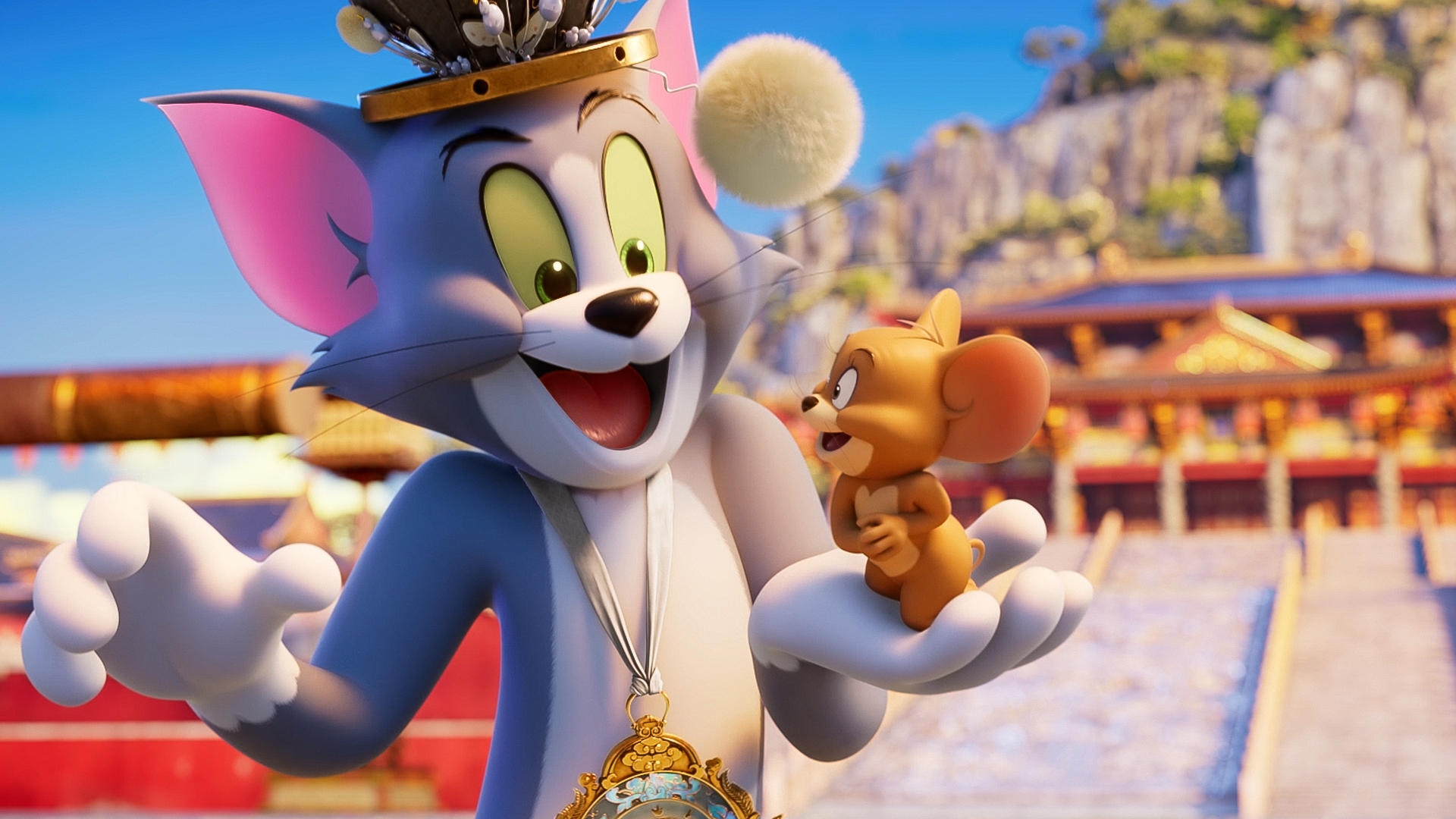 Tom und Jerry stehen vor einem Palast mit einem Berg im Hintergrund.