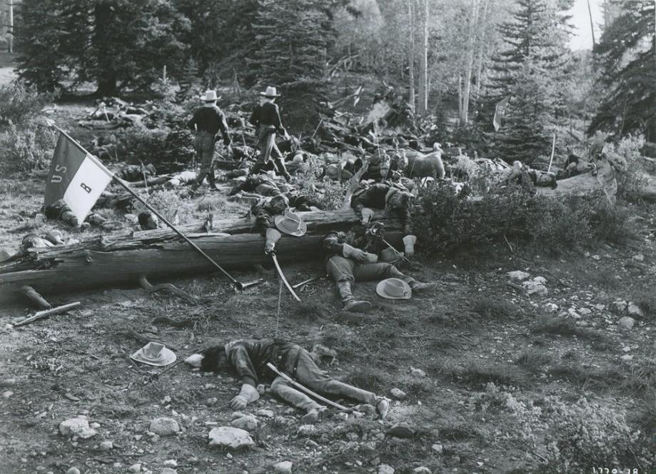 Schlachtfeld mit toten Soldaten und zwei Männern, die aufrecht stehen.