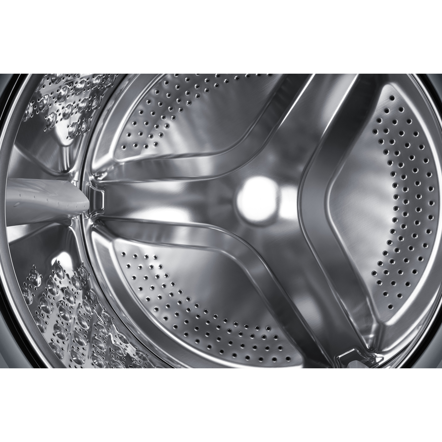 The inside of a shiny washing machine drum with small holes.