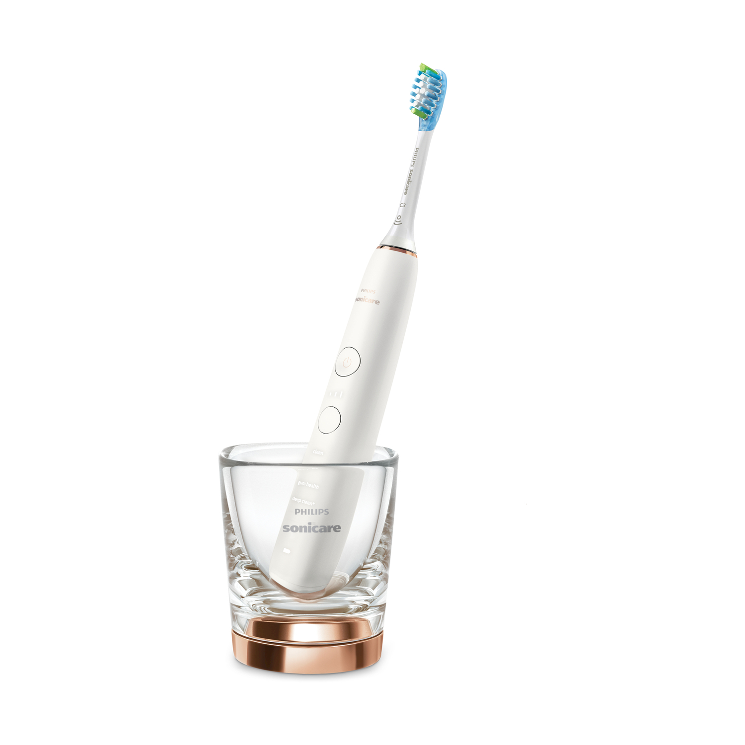 Uno spazzolino elettrico bianco con testina blu e verde è in un bicchiere.