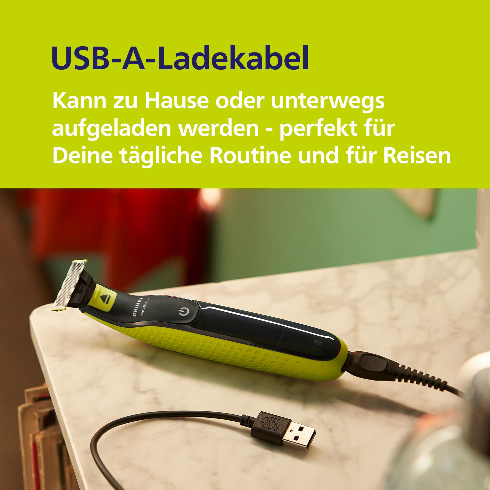 Ein Philips OneBlade Trimmer mit USB-Ladekabel auf marmoriertem Untergrund.