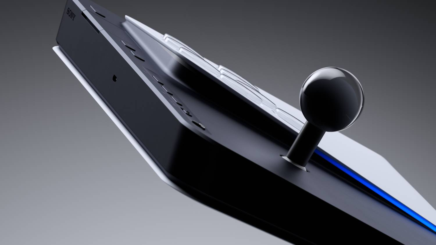 Un joystick negro sobre una consola de juegos blanca y negra con iluminación azul.